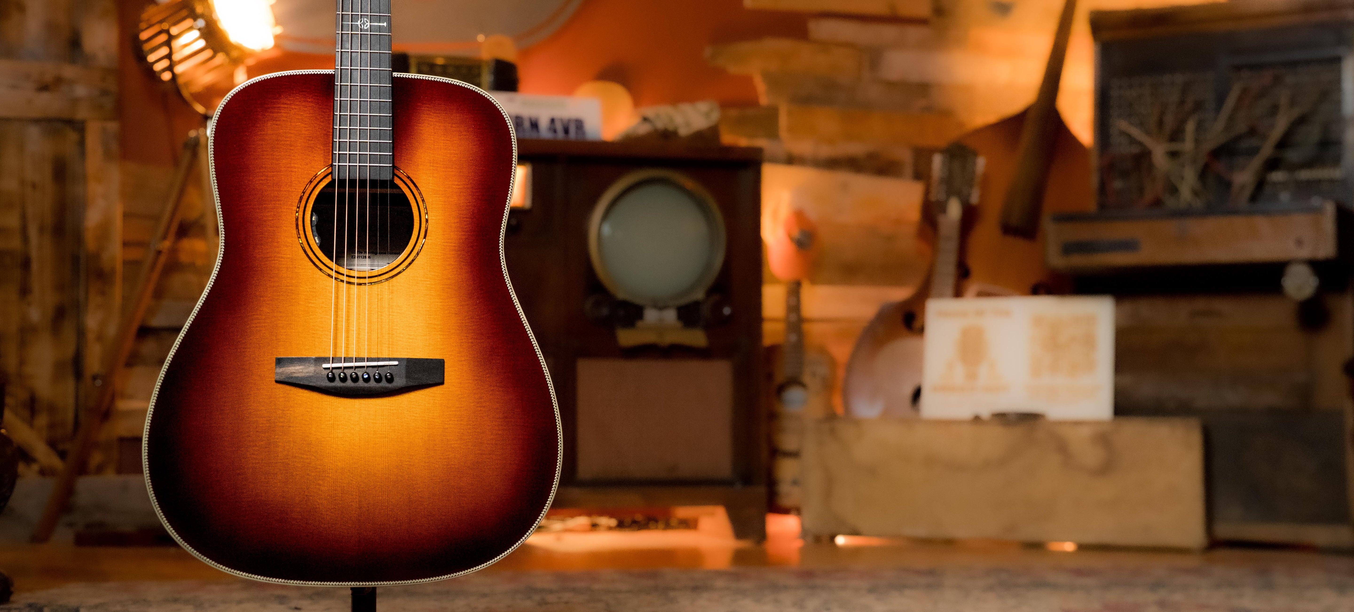 A sunburst acoustic guitar on a stand in a cozy room with vintage decor, including retro electronics, wooden accents, and warm, ambient lighting.