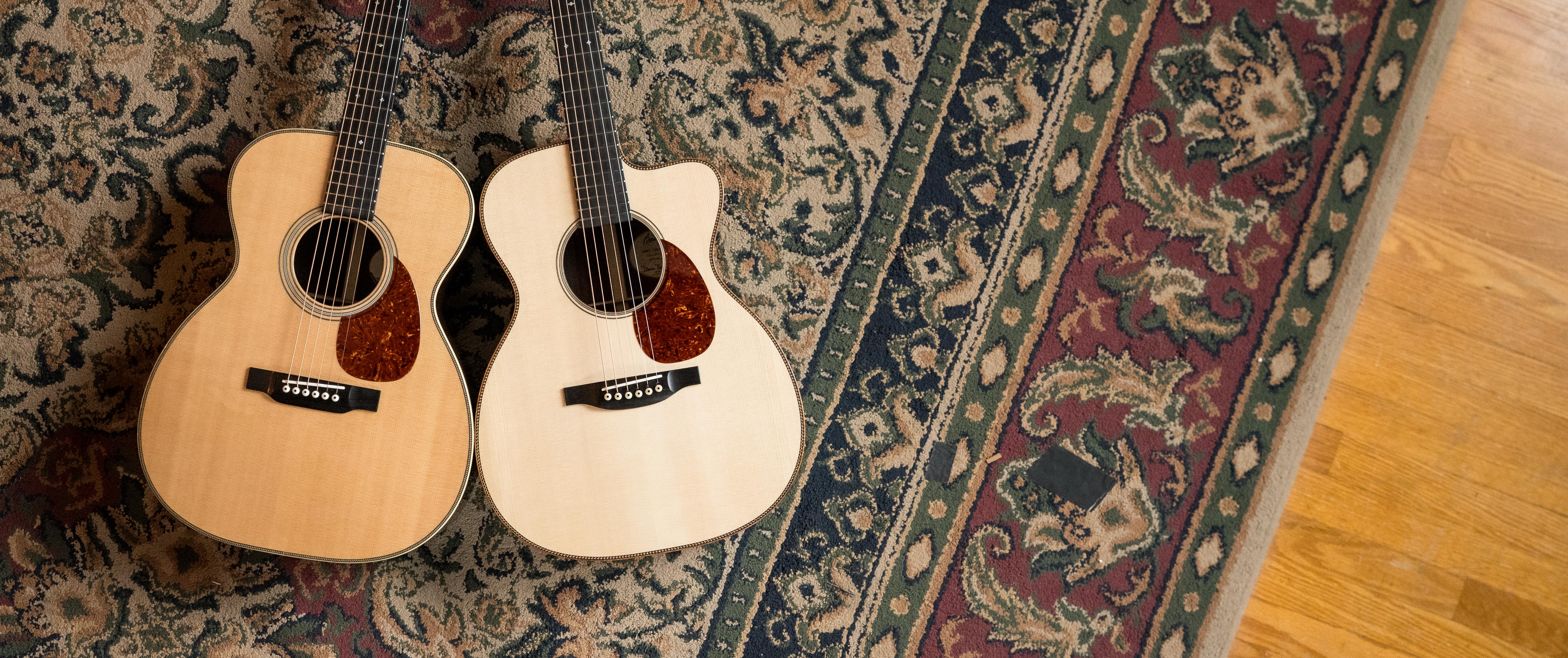 Two Bourgeois Guitars lying next to each other on a rug in The Acoustic Shoppe