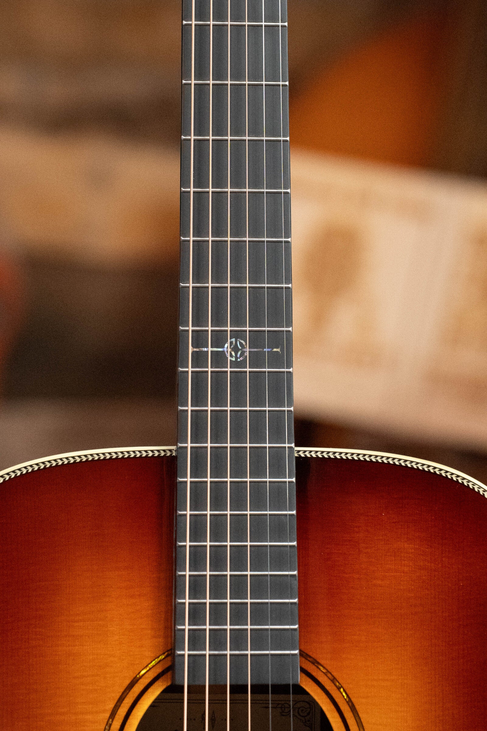 Close-up of the Alvarez Laureate Series LD70e Herringbone Sunset Sitka/Rosewood dreadnought guitar’s neck and upper body, with a dark fretboard, decorative 12th-fret inlay, and sunburst finish. Features LR Baggs Hifi Pickup.