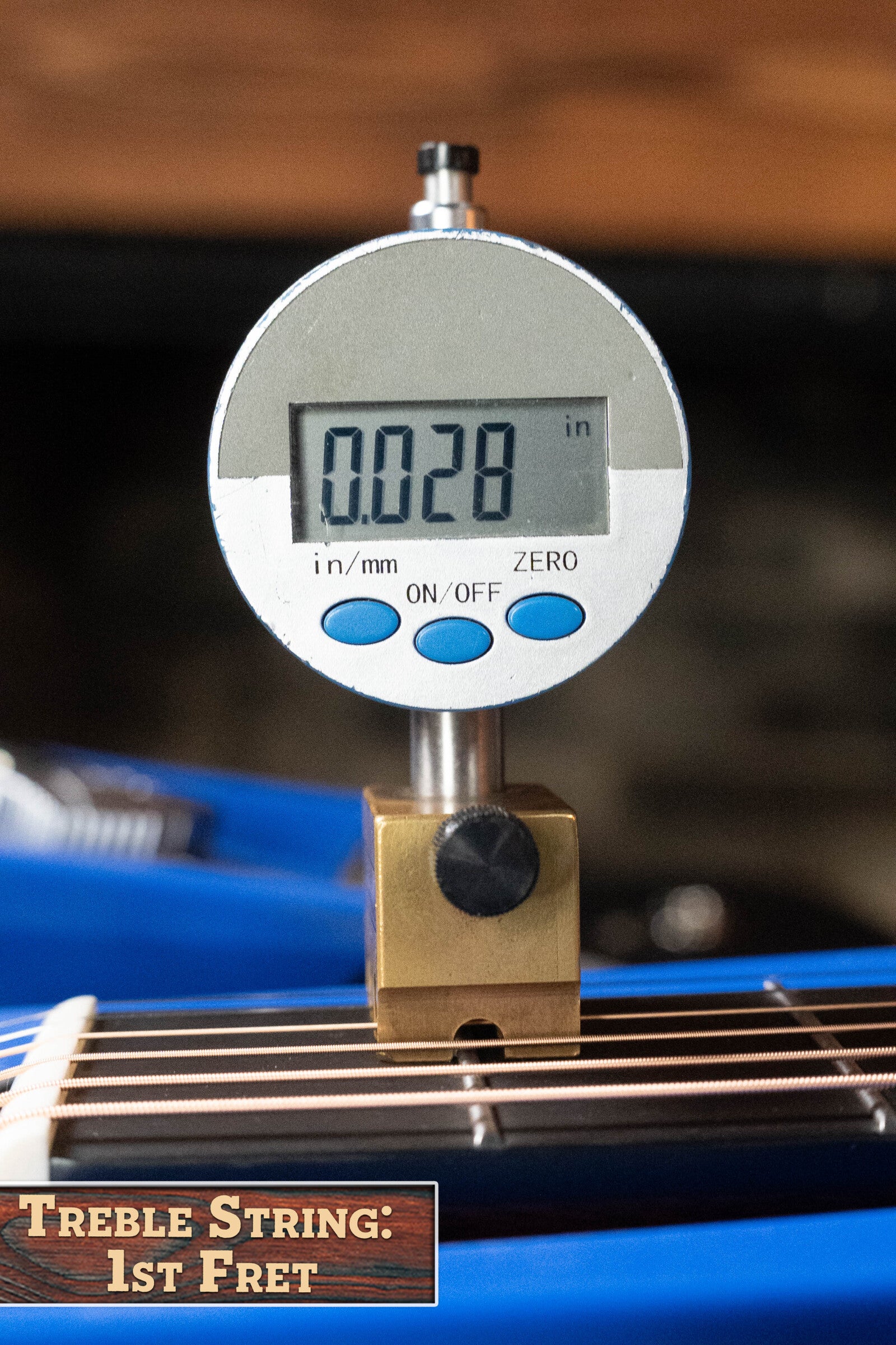 A digital gauge displays 0.028 inches above the treble string at the 1st fret of an Alvarez Laureate Series LD70e Herringbone Sunset Dreadnought Guitar w/LR Baggs Hifi Pickup. "TREBLE STRING: 1ST FRET" is shown at the image's bottom left corner.