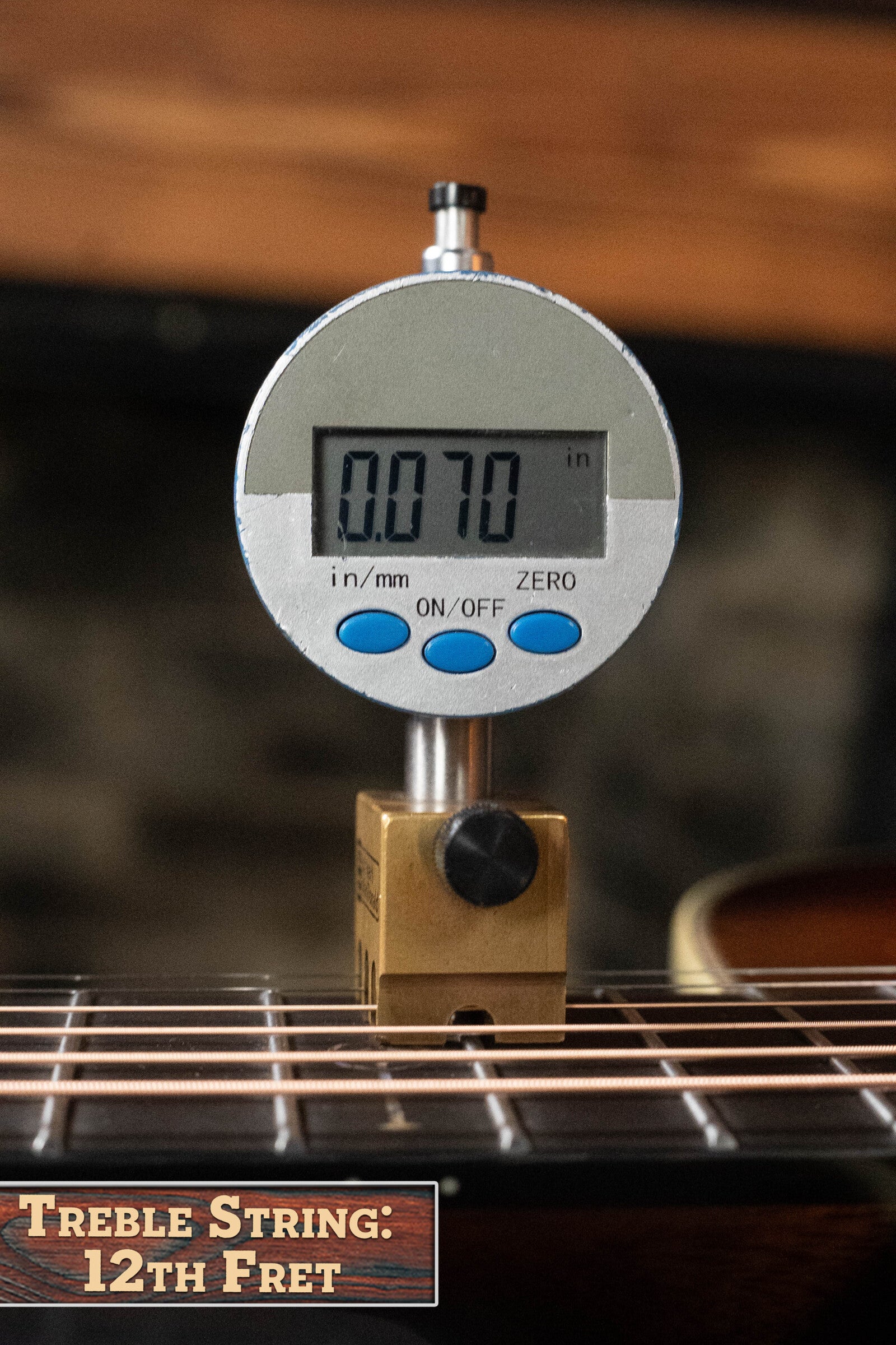 A digital gauge reads 0.070 inches, measuring the treble string height above the 12th fret on an Alvarez Laureate Series LD70e Herringbone Sunset Sitka/Rosewood Dreadnought Guitar w/LR Baggs Hifi Pickup #2044.