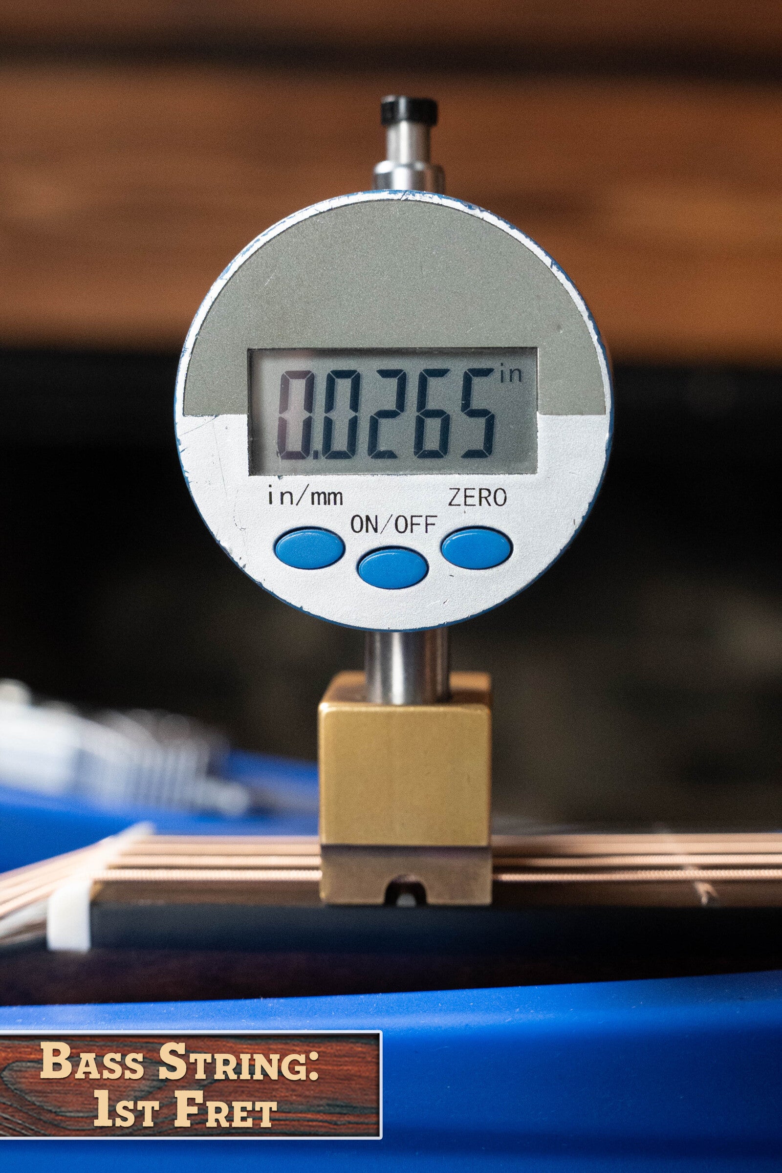 A digital caliper shows 0.265 inches above the first fret of a Bedell Angelica Bellissima Red Cedar/Rosewood Parlor Guitar w/K&K Pure Mini Pickup #5002 by Bedell Guitars, preferred for precision setups. Label: Bass String: 1st Fret.