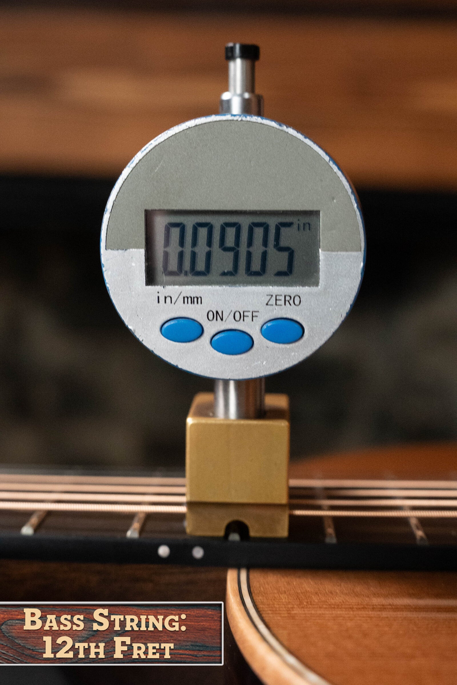 A digital gauge shows the bass string height above the 12th fret as 0.0905 inches on a Bedell Angelica Bellissima Red Cedar/Rosewood Parlor Guitar w/K&K Pure Mini Pickup (#5002) by Bedell Guitars. “Bass String: 12th Fret” appears at lower left.