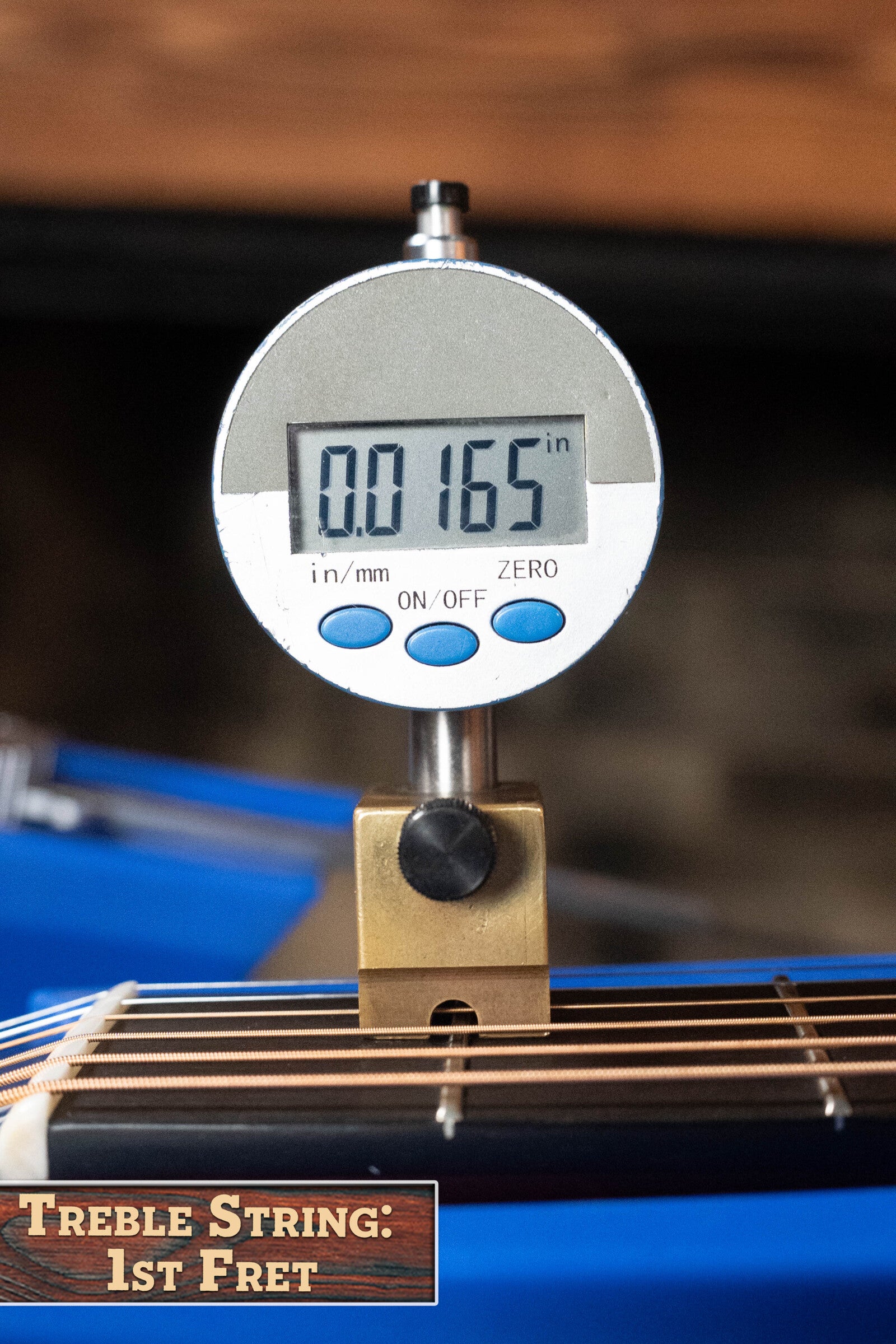 A digital gauge measures the 1st fret treble string height at 0.0165 on a Boucher BG-52-GM Bluegrass Goose Series Dreadnought Acoustic Guitar (#1369) by Boucher Guitars. A label at bottom left reads, Treble String: 1st Fret.