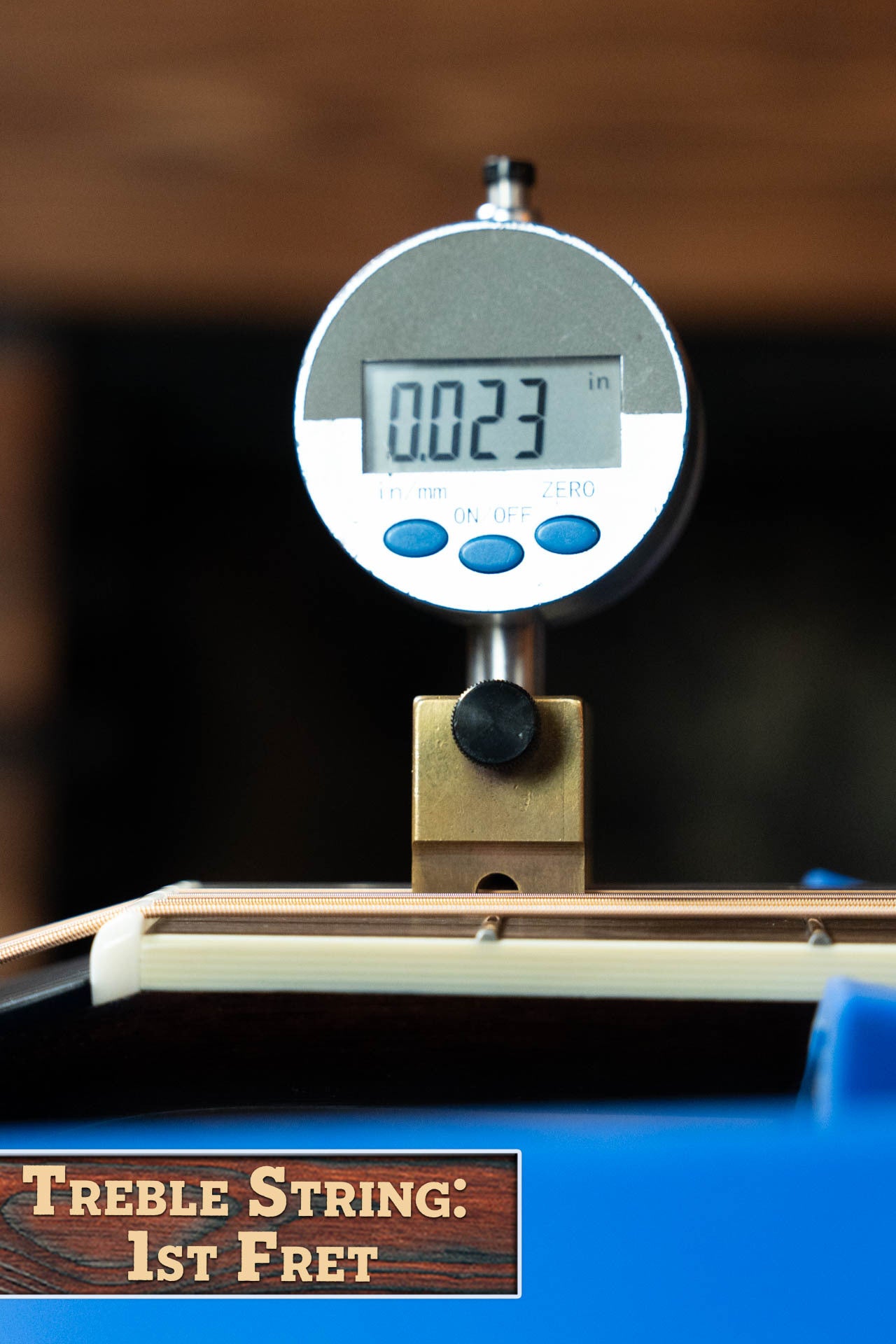 A digital gauge shows 0.023 inches when measuring the treble string height at the 1st fret on a Bourgeois Blues PSBB-LDBO-S Satin Professional Series All Mahogany OO Acoustic Guitar #1197 by Bourgeois. Label: Treble String: 1st Fret.
