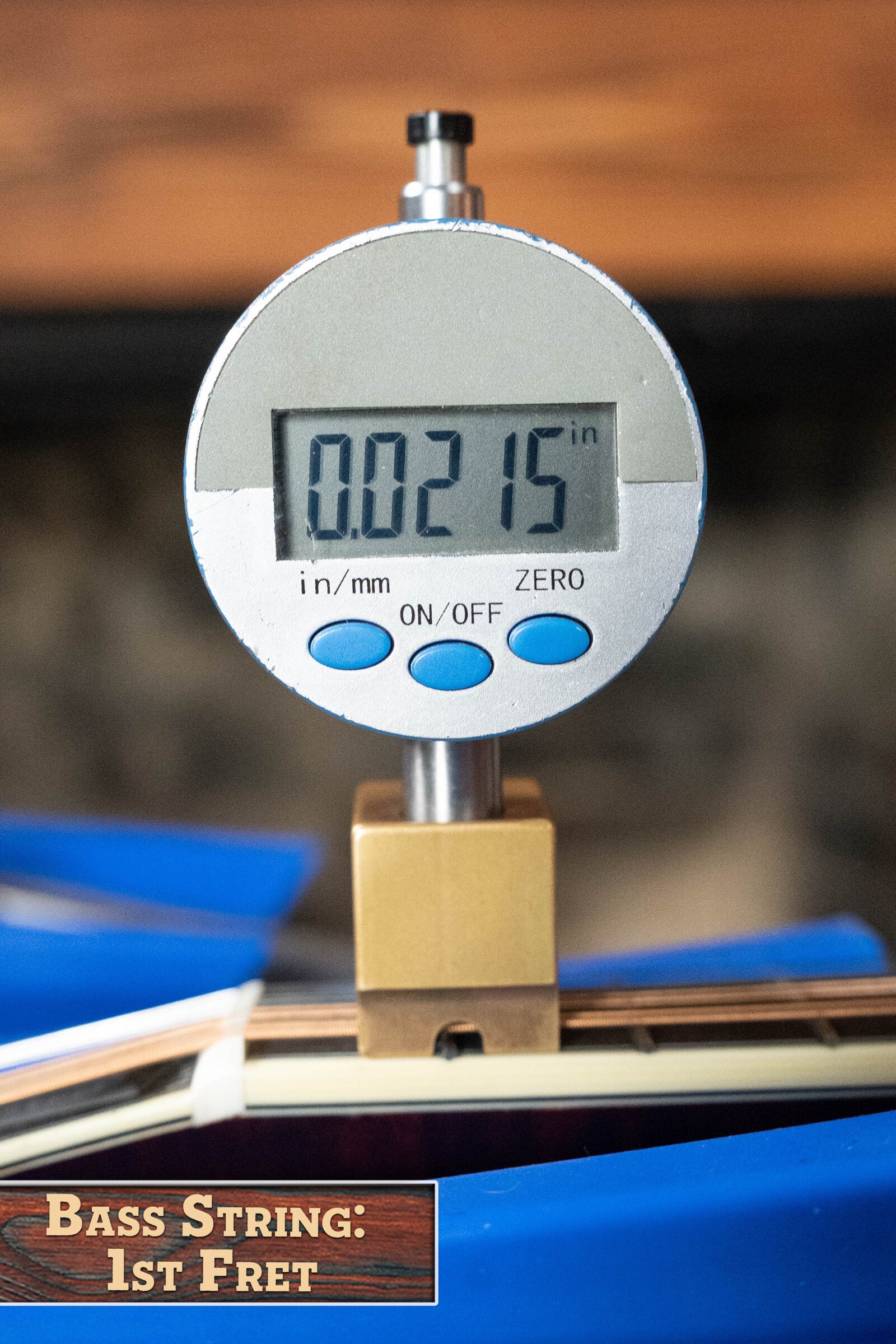 A digital gauge shows 0.0215 for the bass string height at the first fret of a Bourgeois M5-A-BT Aged-Tone Black Top A-Style Mandolin (#2020), with a label reading Bass String: 1st Fret.