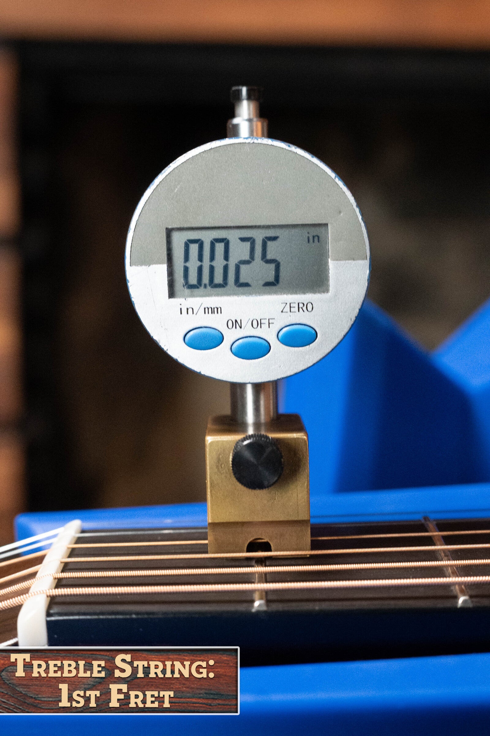 A digital gauge shows 0.025 inches above the 1st fret of a Bourgeois PSV-D-S Professional Series Sitka/Rosewood Dreadnought #1124’s treble string, highlighting its precise setup. Label reads: Treble String: 1st Fret.