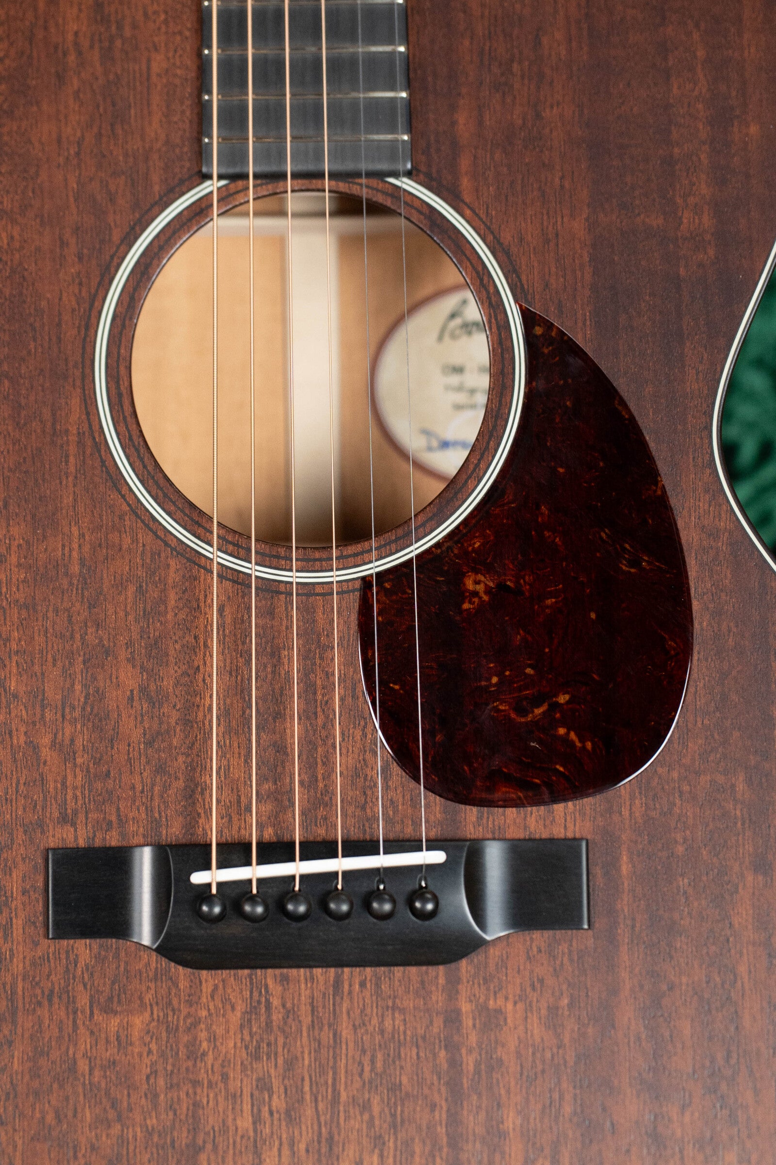 Close-up of a Bourgeois Professional Series Hog Top All Mahogany OM Acoustic Guitars soundhole and bridge