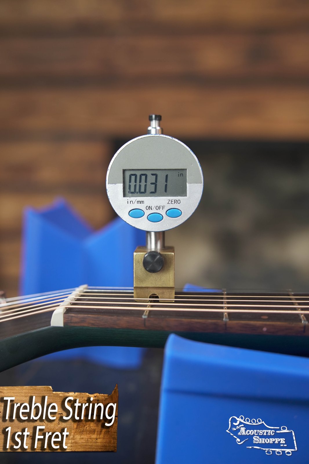 A digital caliper measures the string height above the first fret of a Breedlove Rainforest S Concert Papillon acoustic guitar, reading 0.031 inches. "Treble String 1st Fret" is displayed with an Acoustic Shoppe logo nearby.