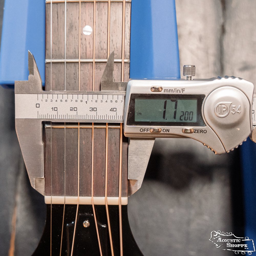 A digital caliper shows 42.00 mm when measuring the nut width of the Guild Guitars USA D-40 Traditional Sitka Spruce/African Mahogany Natural Top Dreadnought #1106, which features six strings and a solid Sitka spruce top.