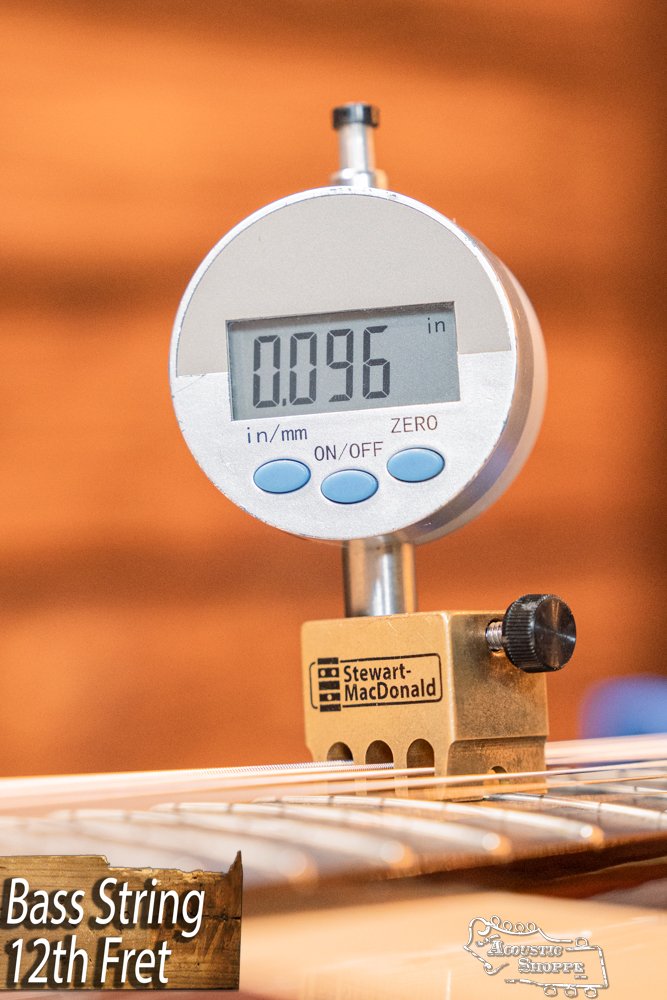A Stewart-MacDonald digital gauge shows a string height of 0.096" at the 12th fret. Text below: Bass String 12th Fret. Ideal for setups on guitars such as the Guild Guitars USA D-40 Traditional Sitka Spruce/African Mahogany #1106 dreadnought.