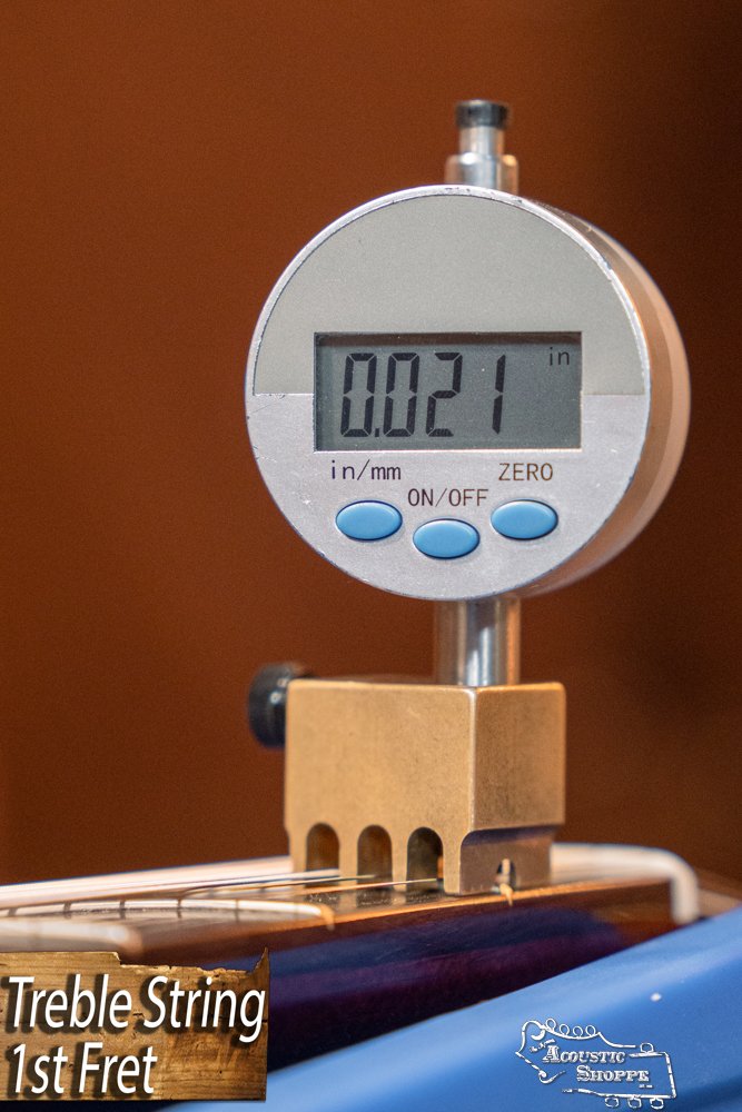 A digital gauge shows 0.021" string height above the first fret on a Guild Guitars USA D-40 Traditional Sitka Spruce/African Mahogany Natural Top Dreadnought #1106. "Treble String 1st Fret" appears with the Acoustic Shoppe logo at the bottom.