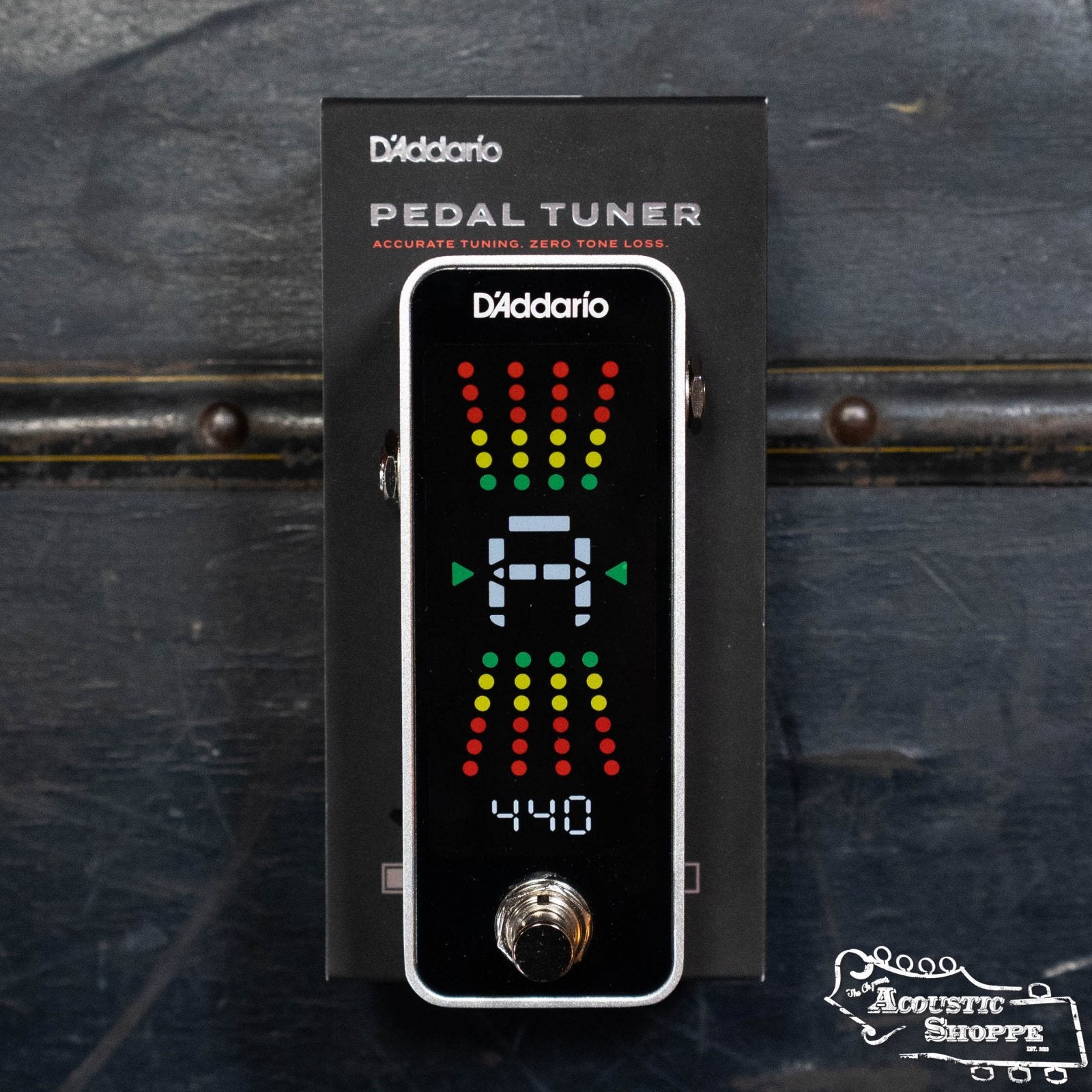 A D'Addario PW-CT-20 Pedal Tuner sits on its box, displaying a full-color vertical screen with LED tuning indicators and “440” at the bottom. The Acoustic Shoppe logo appears in the lower right corner.