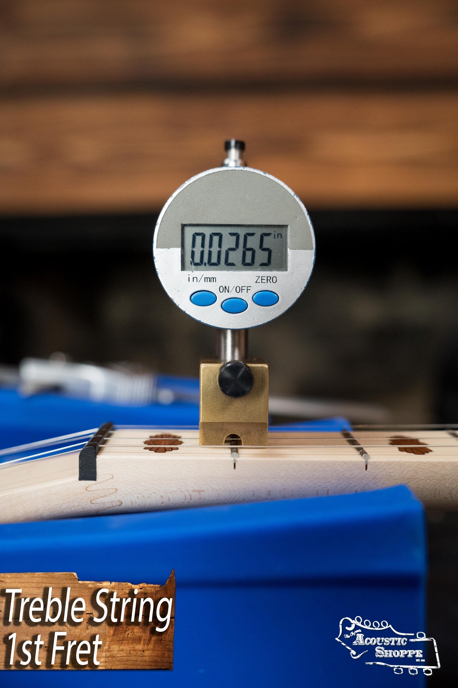 A digital gauge shows a treble string height of 0.0265 at the 1st fret on a Deering Banjos Goodtime Deco 5-String Banjo #52407, with “Treble String 1st Fret” text and The Acoustic Shoppe logo in the bottom right corner.