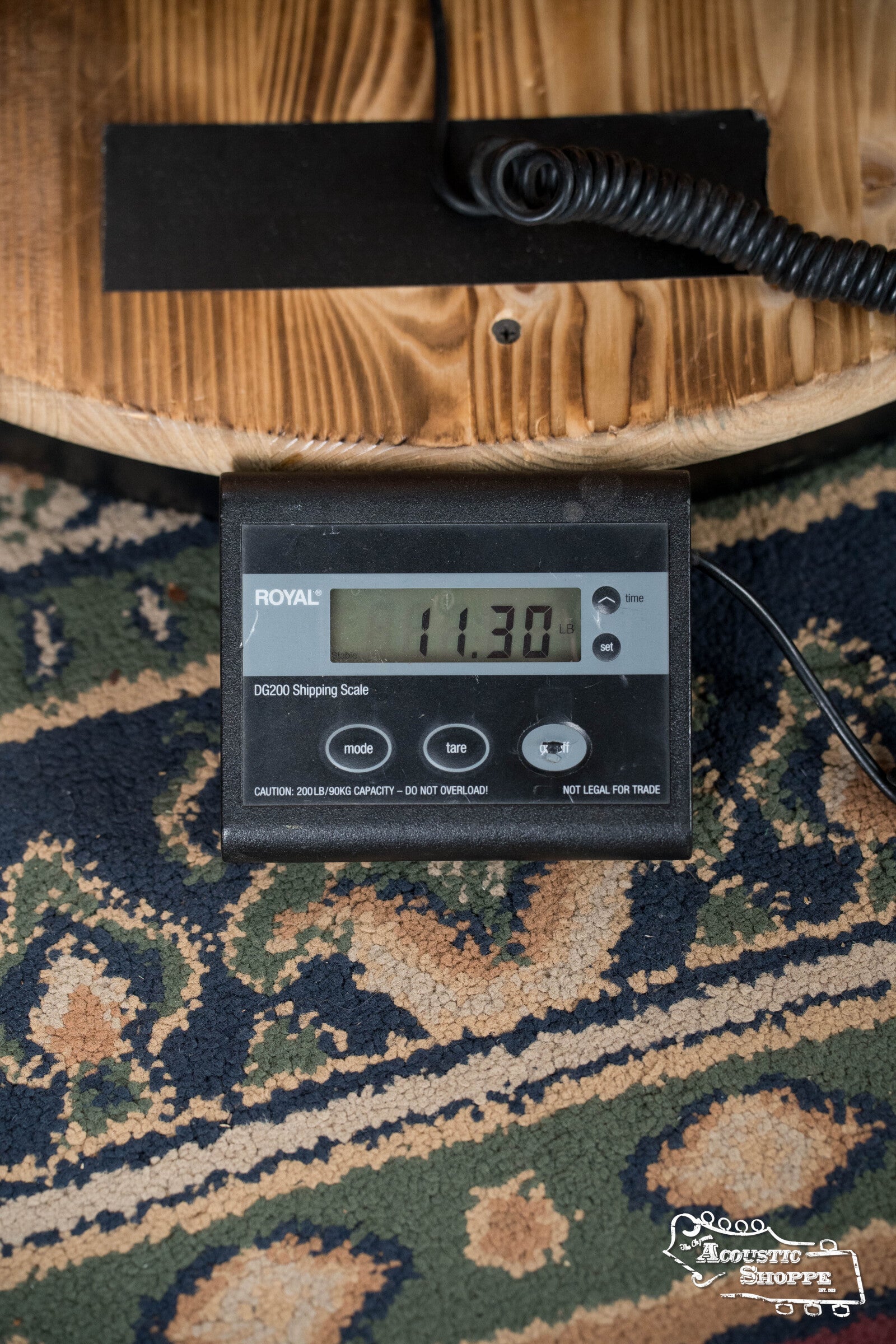 A ROYAL DX200 Shipping Scale on a patterned carpet reads 11.30 lbs, weighing part of a Deering Banjos Rustic Wreath 5-String Resonator Banjo #AU45.