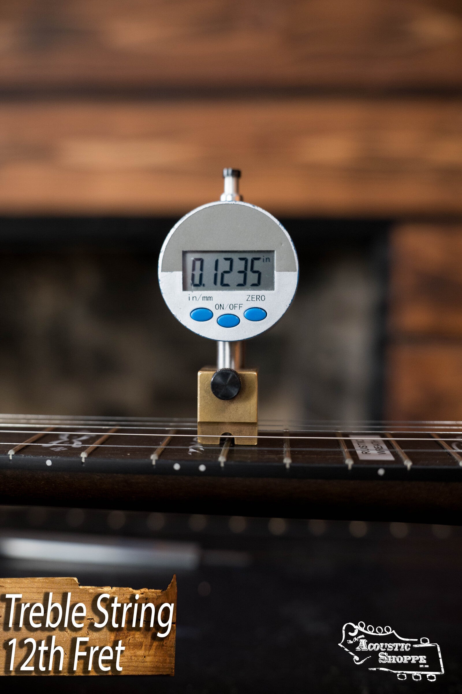 A digital gauge shows 0.1235 in. for the treble string height at the 12th fret, with Treble String 12th Fret text and Acoustic Shoppe logos next to a Deering Banjos Rustic Wreath 5-String Resonator Banjo #AU45.