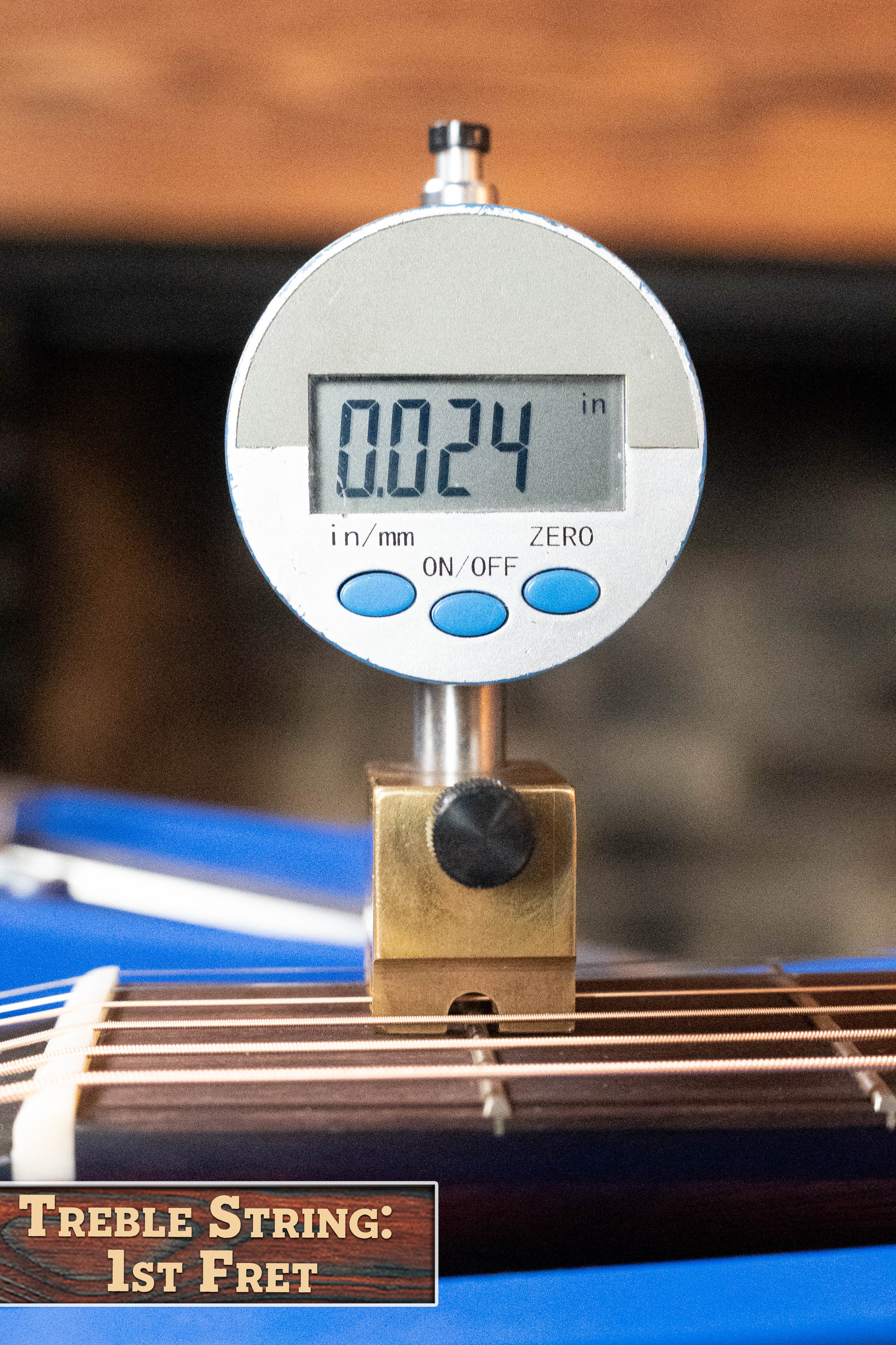 A digital gauge shows 0.024 inches string height above the 1st fret of an *Eastman Guitars Dread-Not Certified Used* E6-LGSS-TC-SB Slope Shoulder Sunburst Acoustic (#9323) labeled “Treble String: 1st Fret.”.