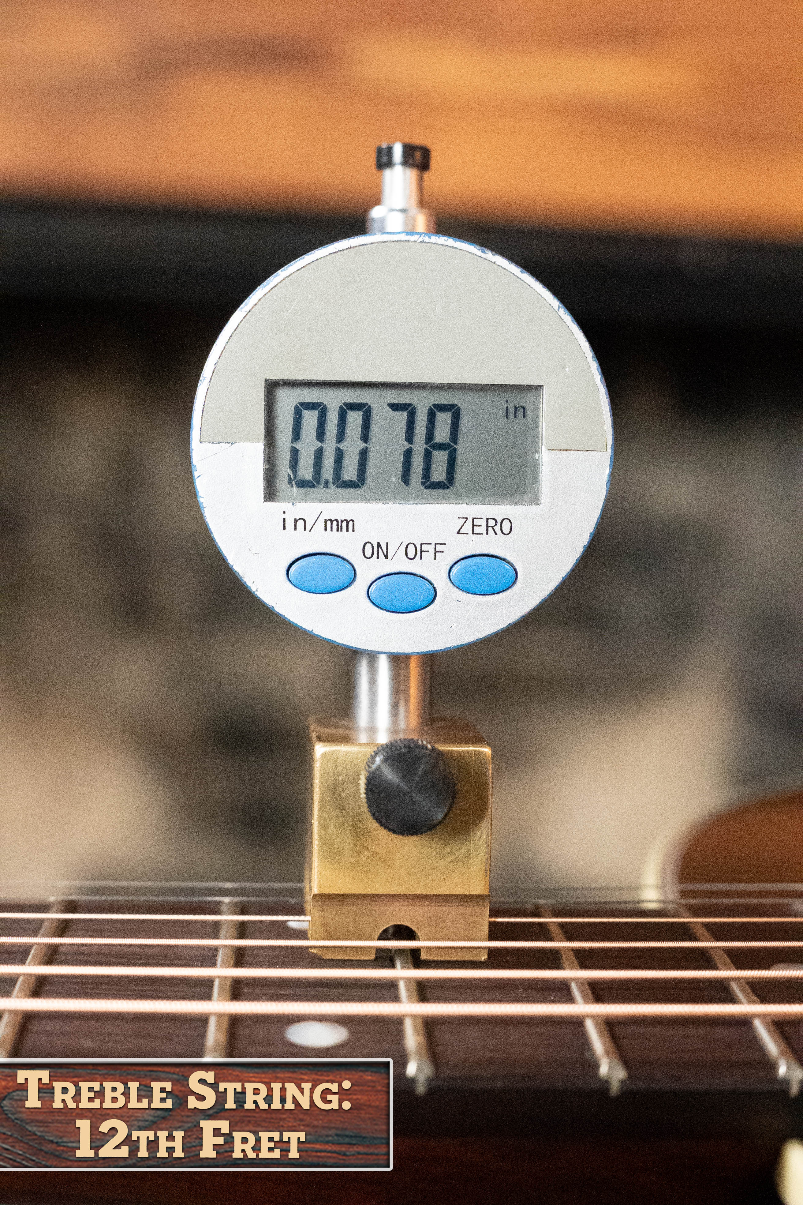 A digital gauge shows the treble string action at the 12th fret as 0.078" on the *Dread-Not Certified Used* Eastman Guitars E6-LGSS-TC-SB Slope Shoulder Sunburst Acoustic Guitar #9323. Text reads “Treble String: 12th Fret.”.