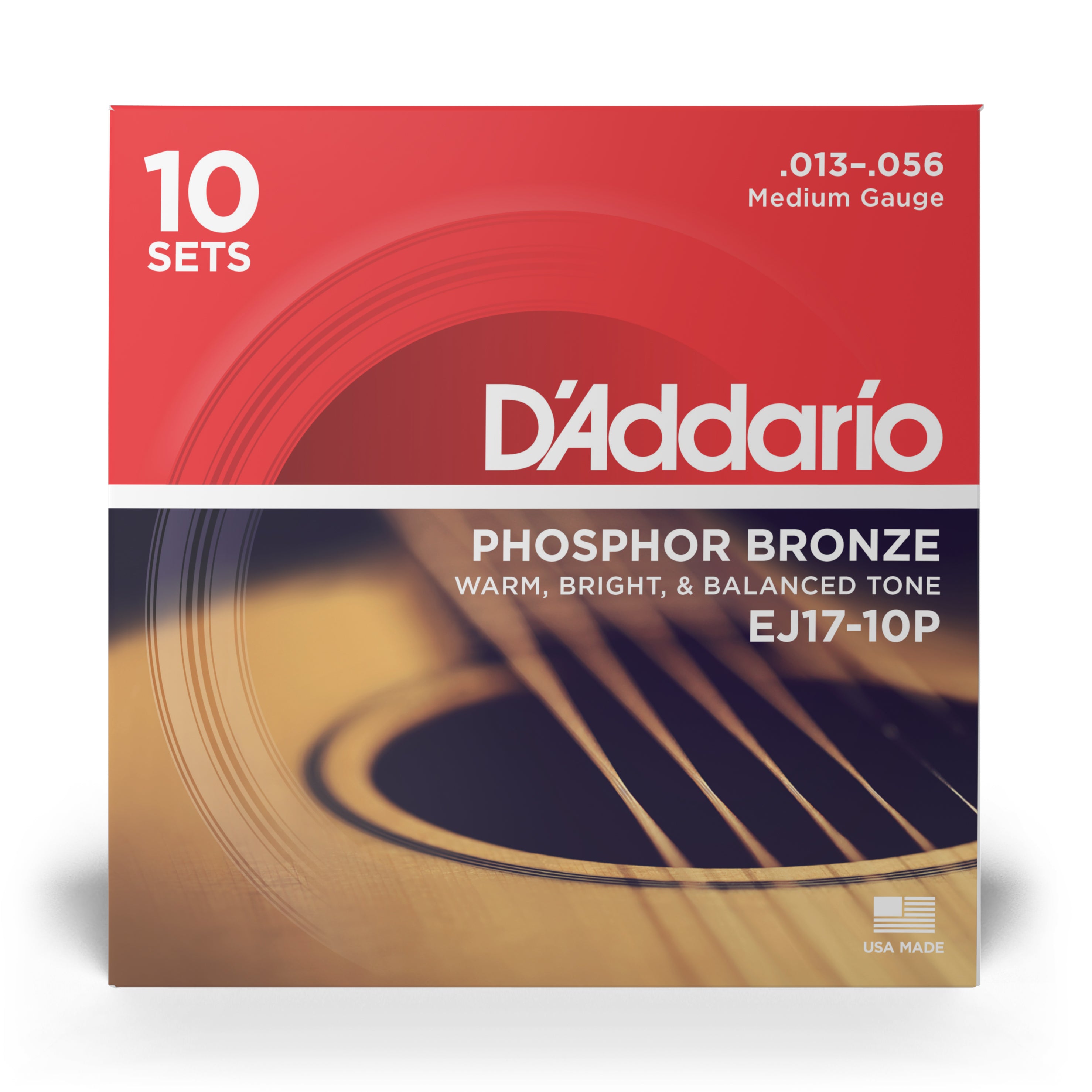 Close-up of a DAddario EJ17-10P Phosphor Bronze Acoustic Guitar Strings box, Medium 13-56 gauge, 10-set pack, with Warm, Bright & Balanced Tone label and part of an acoustic guitar in the background.