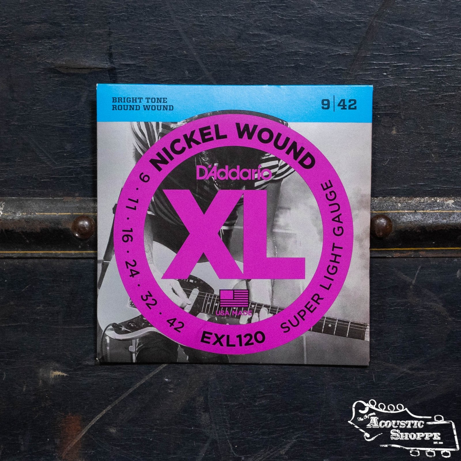 A pack of D'Addario EXL120 Nickel Wound Electric Guitar Strings Super Light 9-42 features a purple and blue design on a dark surface, with The Acoustic Shoppe logo visible in the bottom right corner.