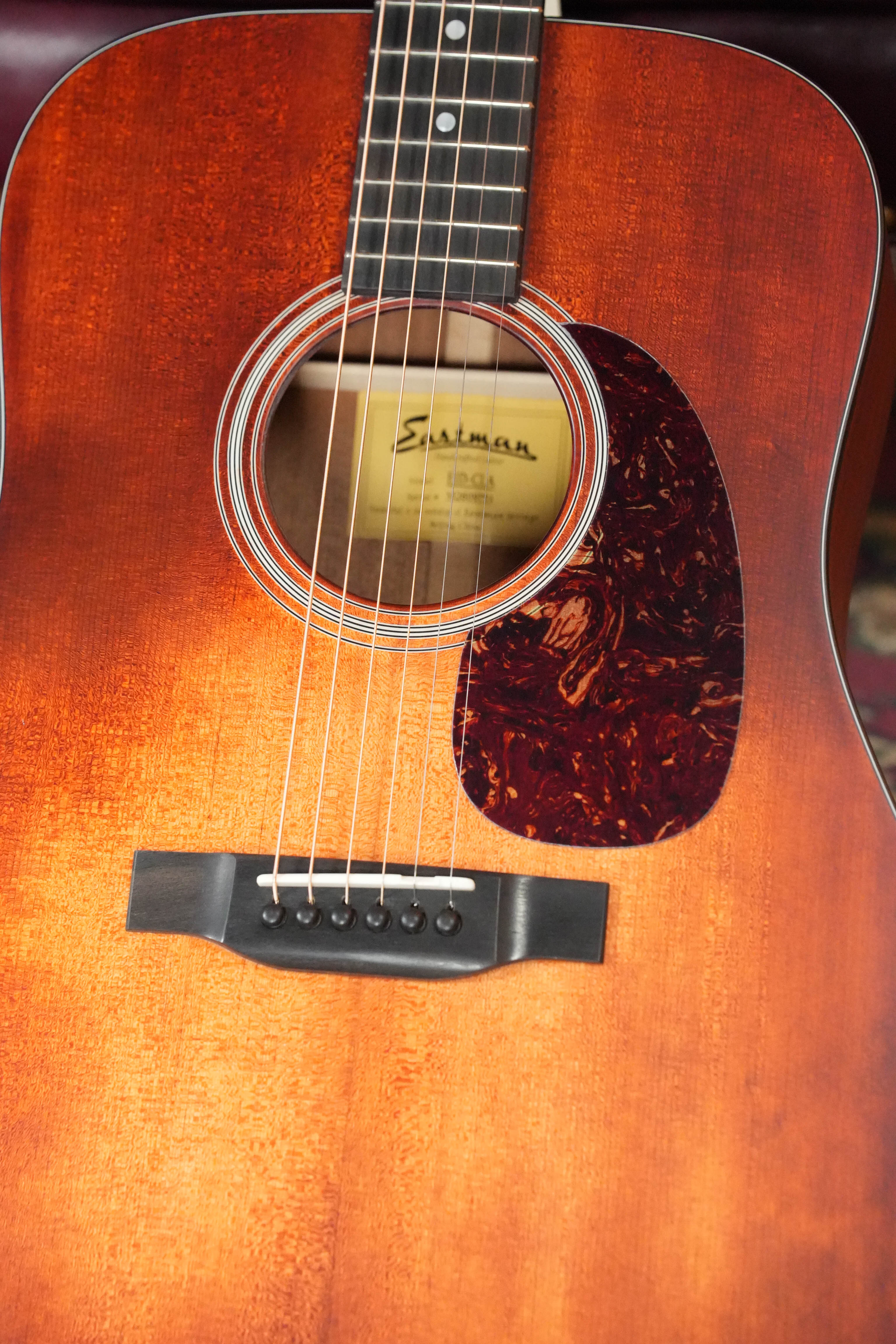 Close-up of an Eastman Guitars E1D-CLA Classic Finish Dreadnought Acoustic Guitar #9753, showing the sunburst-style top, visible strings, pickguard, and soundhole with the Eastman brand inside that highlights quality craftsmanship.