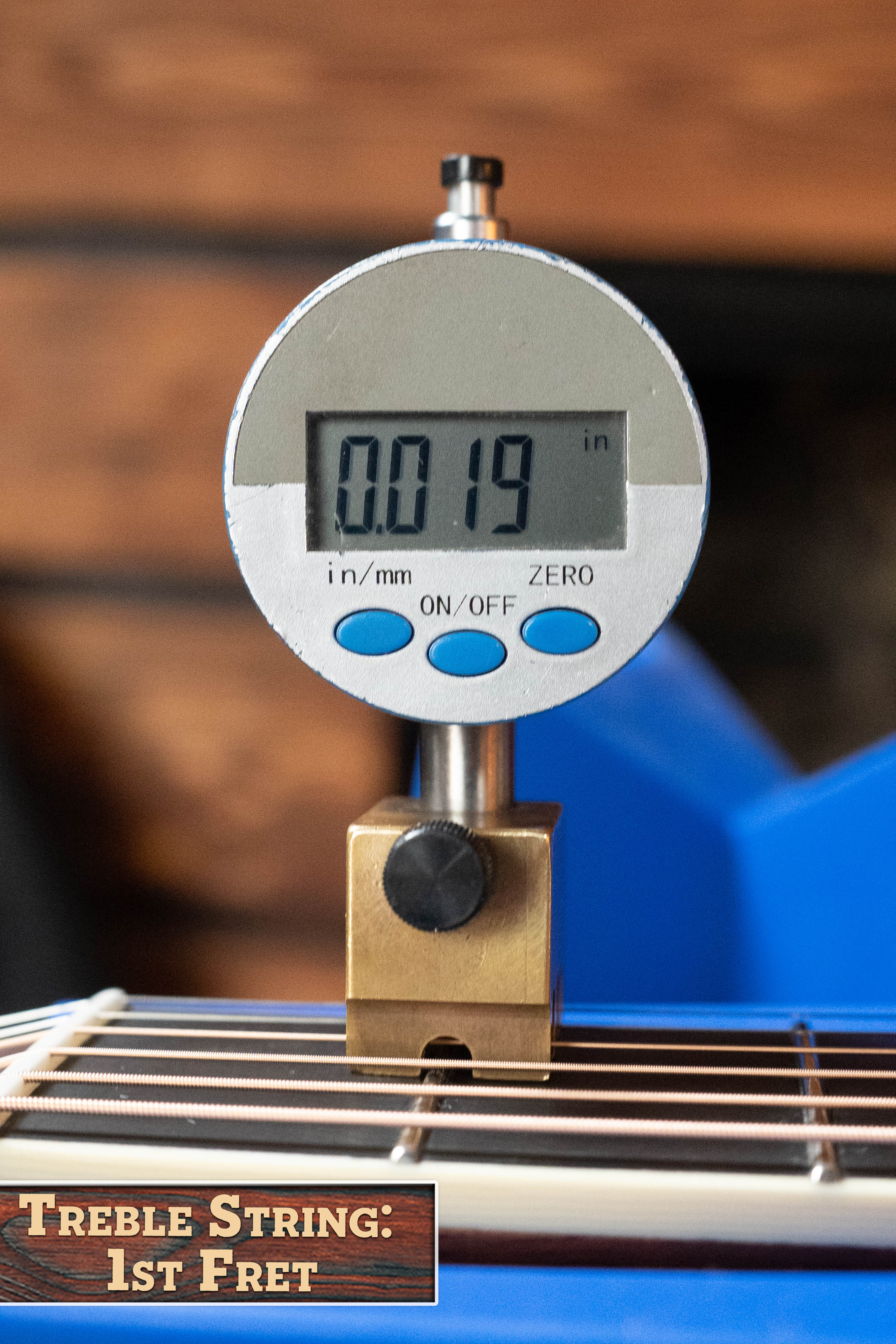 A digital gauge shows 0.019 in while measuring the treble string height at the 1st fret of an Eastman Guitars E20D-LSH-TC Thermo-Cured Adirondack/Rosewood Large Soundhole Dreadnought Acoustic Guitar #8072.