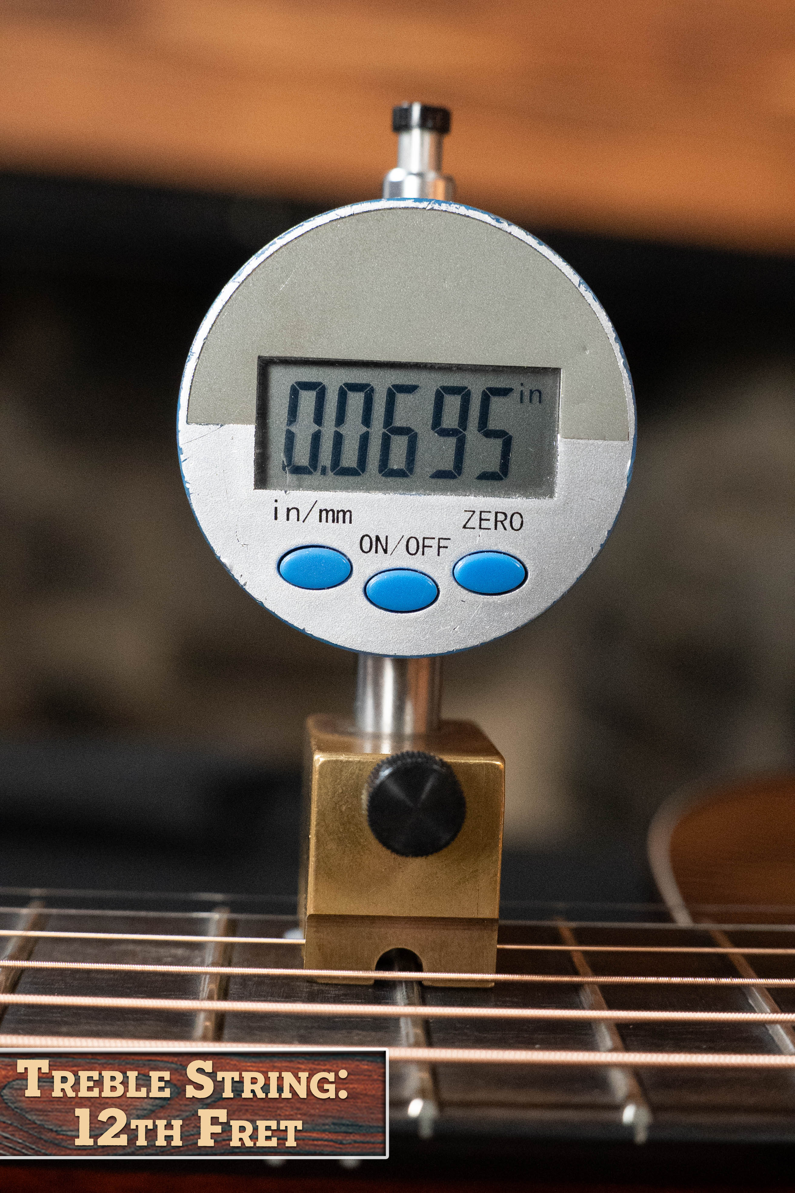 A digital gauge shows the string height above the 12th fret on an Eastman Guitars E2D-DLX-SB Cedar/Sapele Sunburst Dreadnought w/Fishman Pickup (#1532) as 0.0695 inches, labeled TREBLE STRING: 12th FRET.