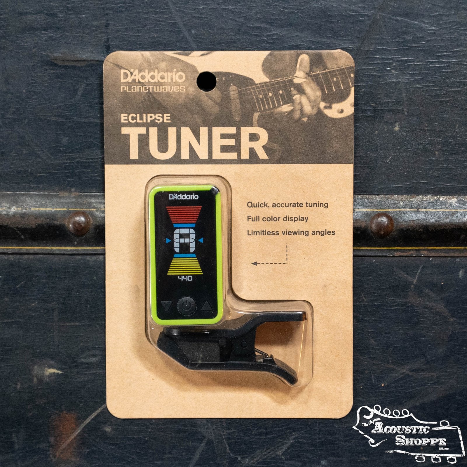 A D’Addario Eclipse Headstock Tuner in packaging features a color display and clip-on chromatic design for precise tuning. D'Addario branding, description, a partial guitar image, and The Acoustic Shoppe logo appear on the box.