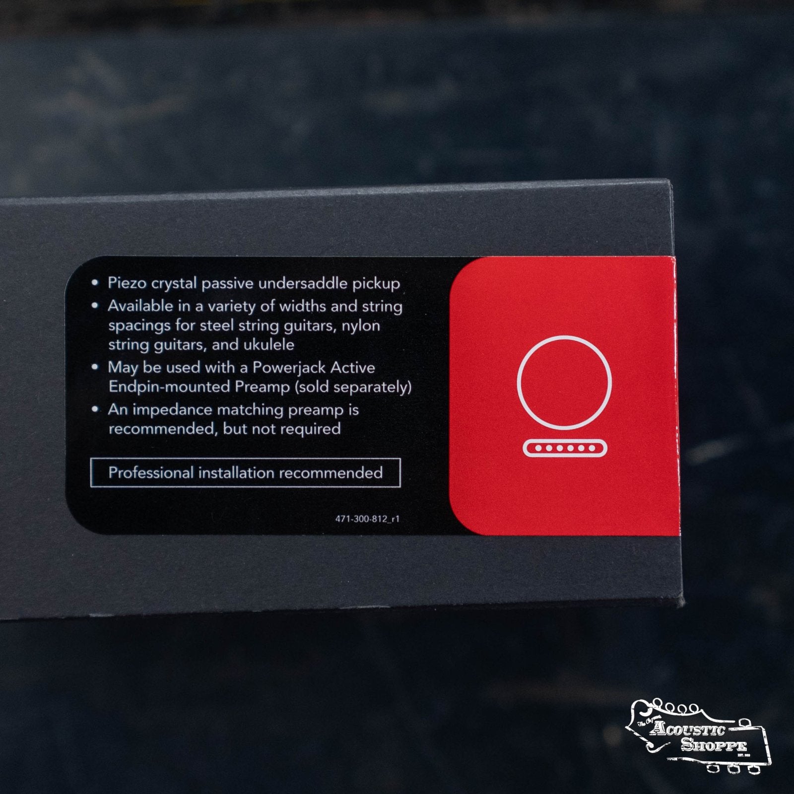 A product box with a label describing the Fishman AG-Series Undersaddle Pickup for 6-string guitar (PRO-AG0-094), noting compatibility and preamp tips. The Acoustic Shoppe logo appears in the bottom right corner.