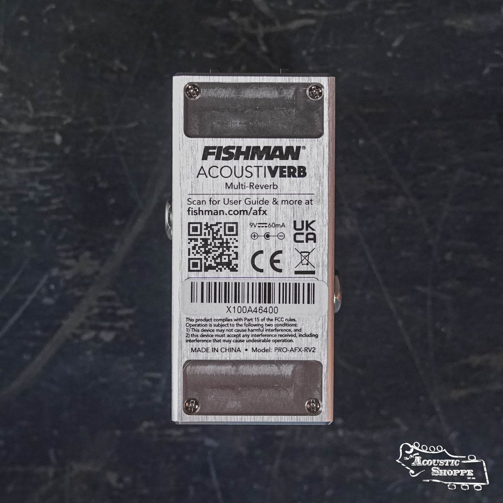The image shows the bottom of a Fishman AFX AcoustiVerb Mini Reverb Pedal PRO-AFX-RV2, displaying a barcode, QR code, technical info, and certification labels on a dark, textured surface.
