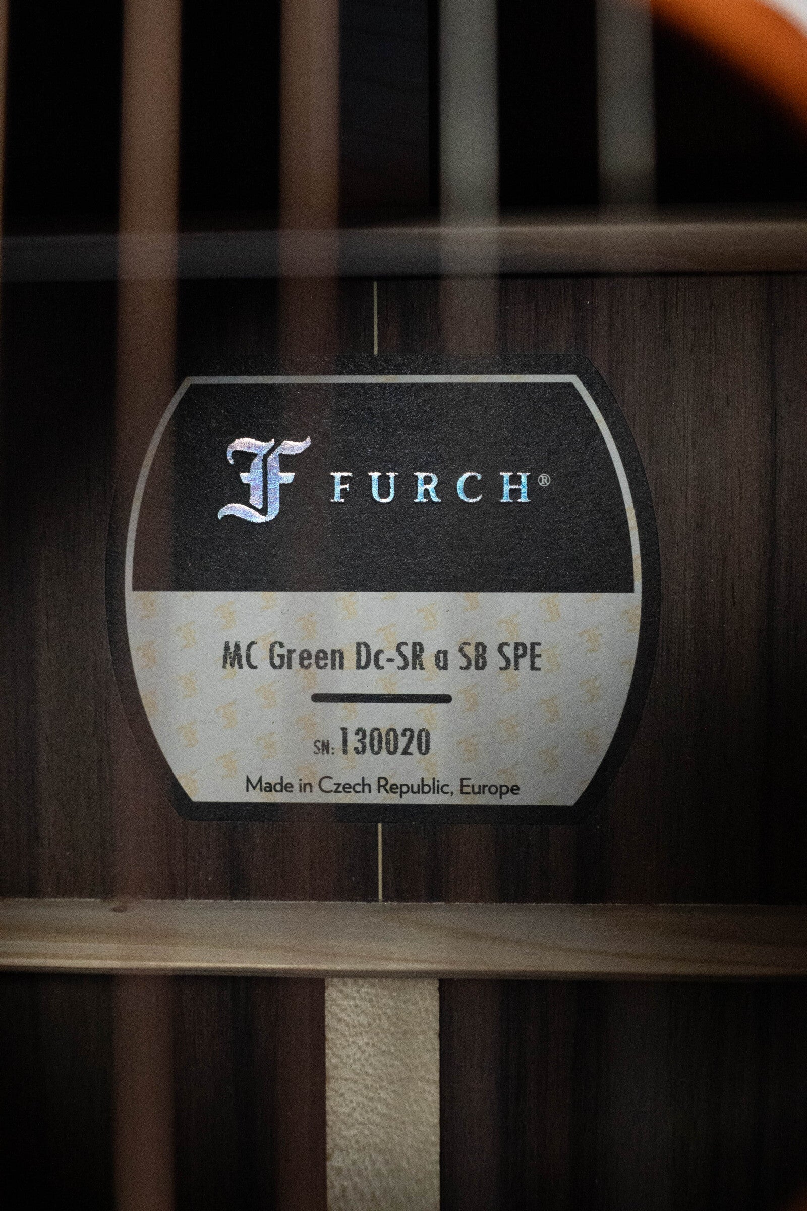 Close-up of a Furch Masters Choice Green SB Dc-SR AA Sitka/AA Indian Rosewood Dreadnought Cutaway Sunburst Guitar w/LR Baggs Pickup #0020 label inside the soundhole, showing model and serial number. Made in Czech Republic.