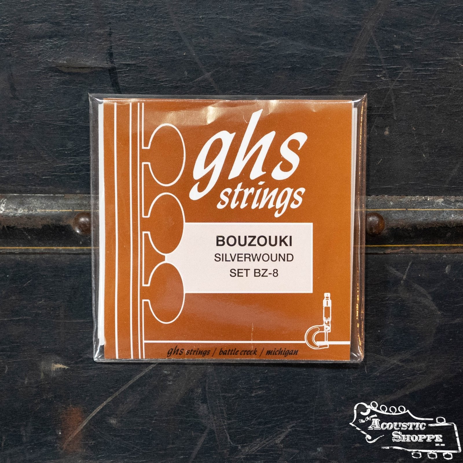 A pack of GHS Strings 8-string Bouzouki (BZ-8) rests on a dark surface, its brown packaging with white text and graphics featuring The Acoustic Shoppe logo—perfect for any Greek Bouzouki player.
