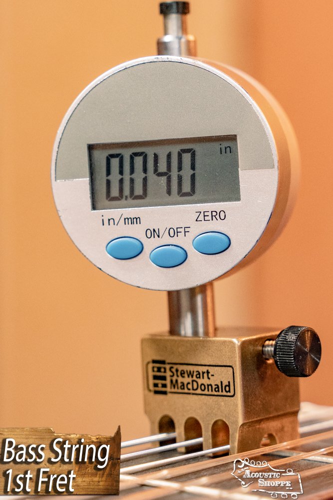 A digital gauge measures the bass string height at the 1st fret of a Cordoba C3M Red Cedar/Mahogany Classical Guitar #8691, displaying 0.040 inches. Brand: Cordoba. Text reads Bass String 1st Fret.