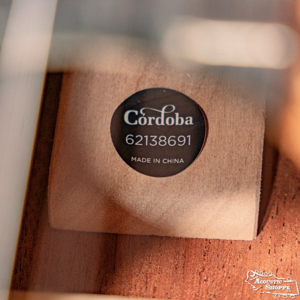 A close-up shows the Cordoba C3M Red Cedar/Mahogany Classical Guitar #8691 label, with Cordoba and Made in China visible on a wooden surface.