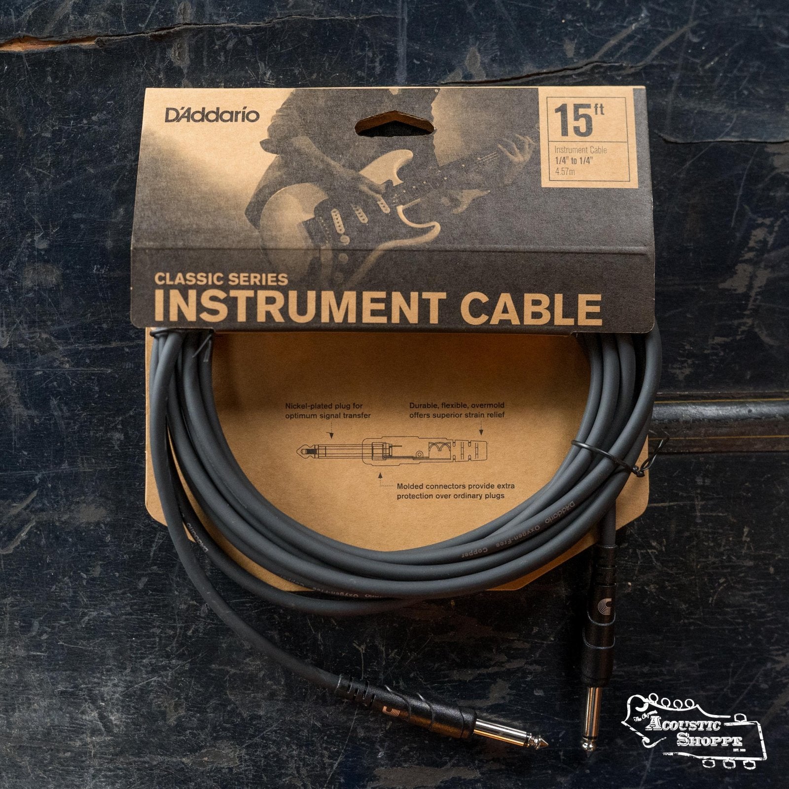 A D'Addario PW-CGT Classic Series Instrument Cable (15ft, straight to straight), made with oxygen-free copper for superior noise rejection, comes in a branded cardboard package on a dark surface featuring The Acoustic Shoppe logo.