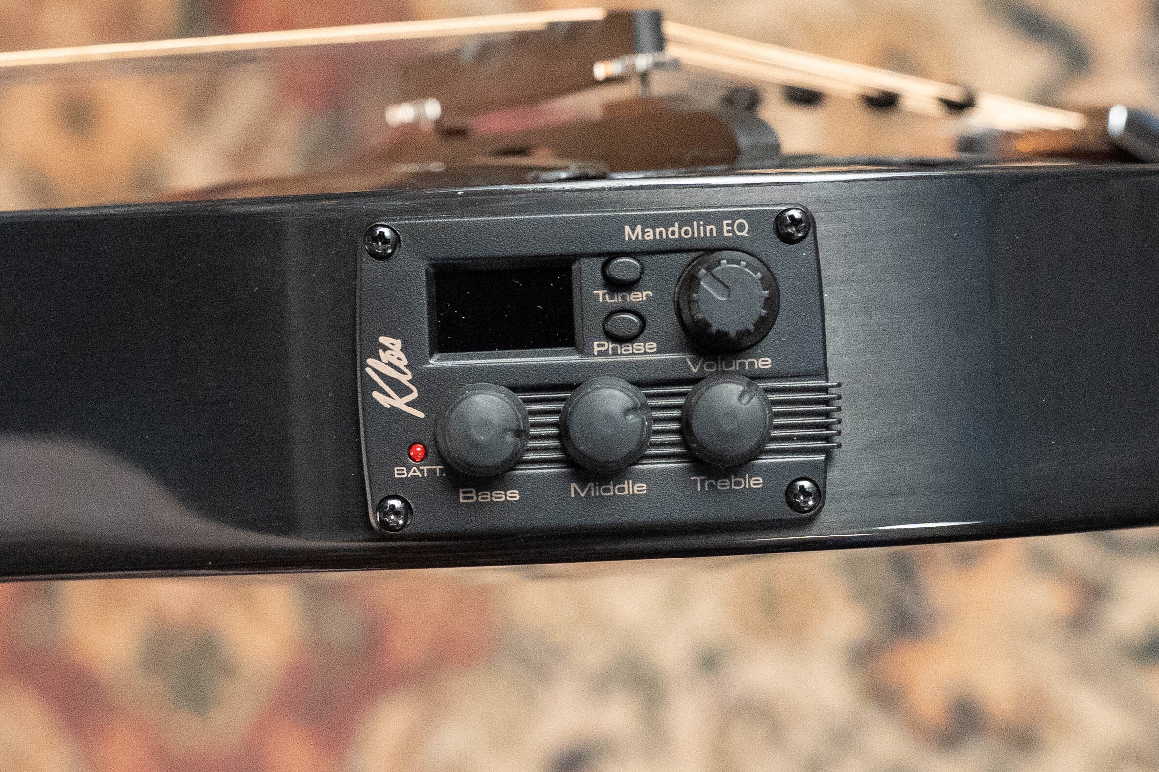 Close-up of a black KLOS EQ Pickup control panel on the KLOS Guitars CT_MA_DAE_EQ Full Carbon Unidirectional Black A-Style Mandolin (#4889), showing labeled bass, middle, treble, and volume knobs, tuner display, phase switch, and the Kluson logo.