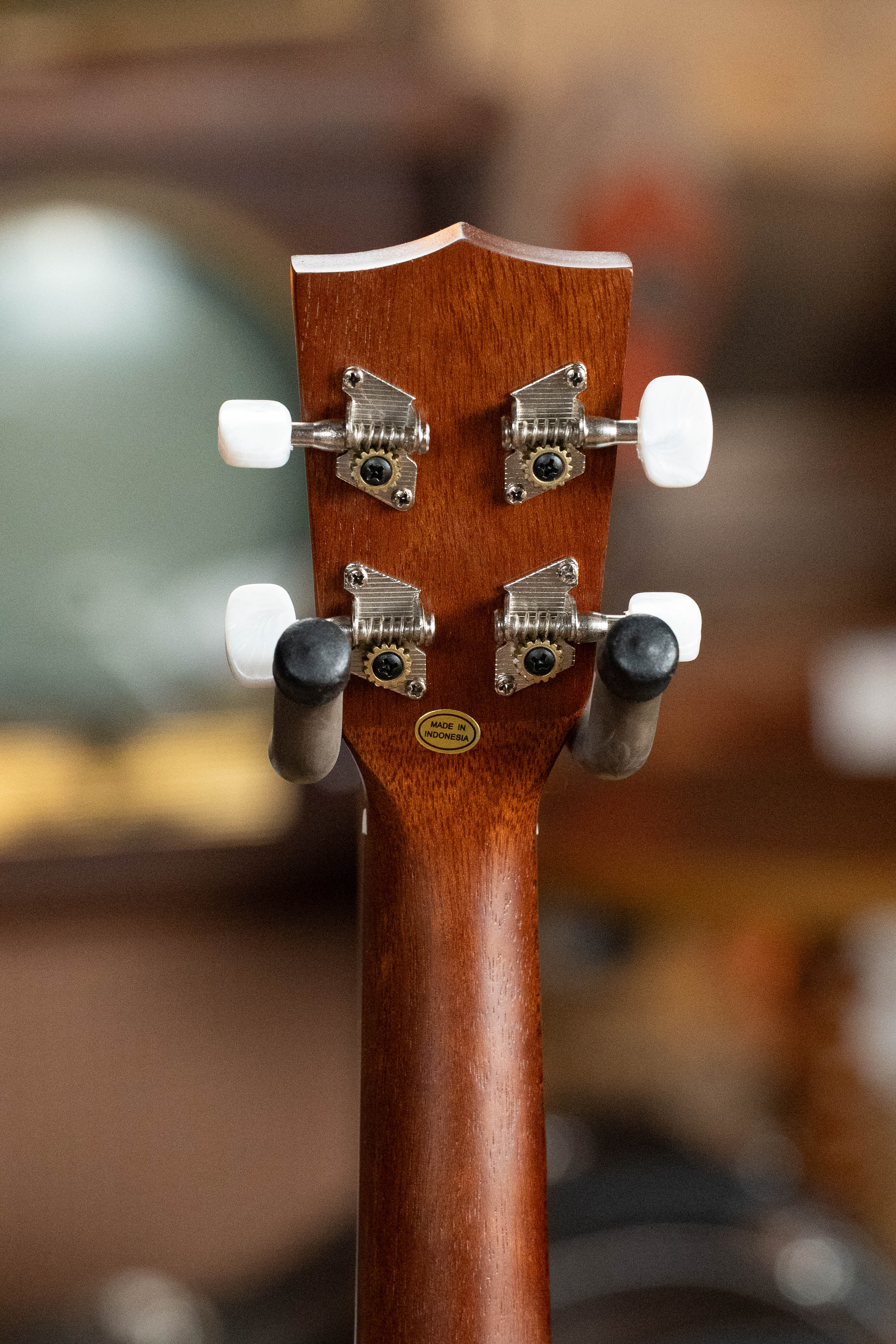 Back view of satin mahogany soprano ukulele headstock with white tuning pegs and gold Kala logo badge. - Kala KA-15S Satin Mahogany Soprano Ukulele - Default Title