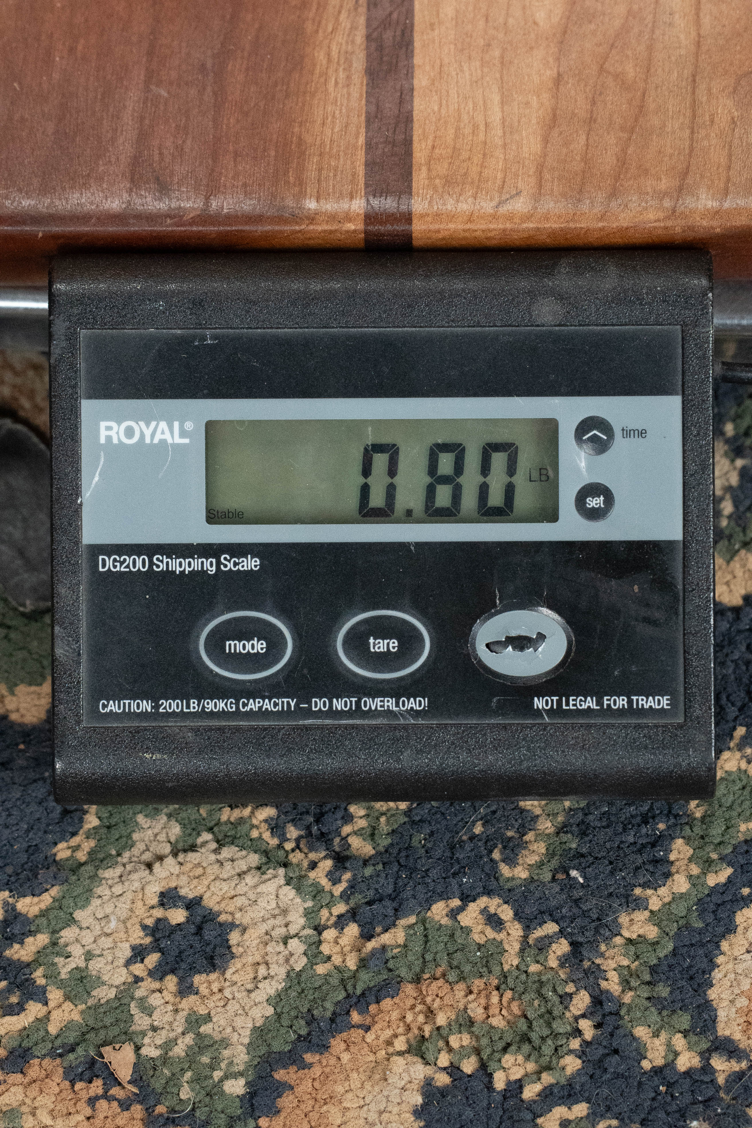 Kala KA-15S Satin Mahogany Soprano Ukulele resting on a patterned carpet with a digital scale showing 0.80 kg. - Kala KA-15S Satin Mahogany Soprano Ukulele - Default Title