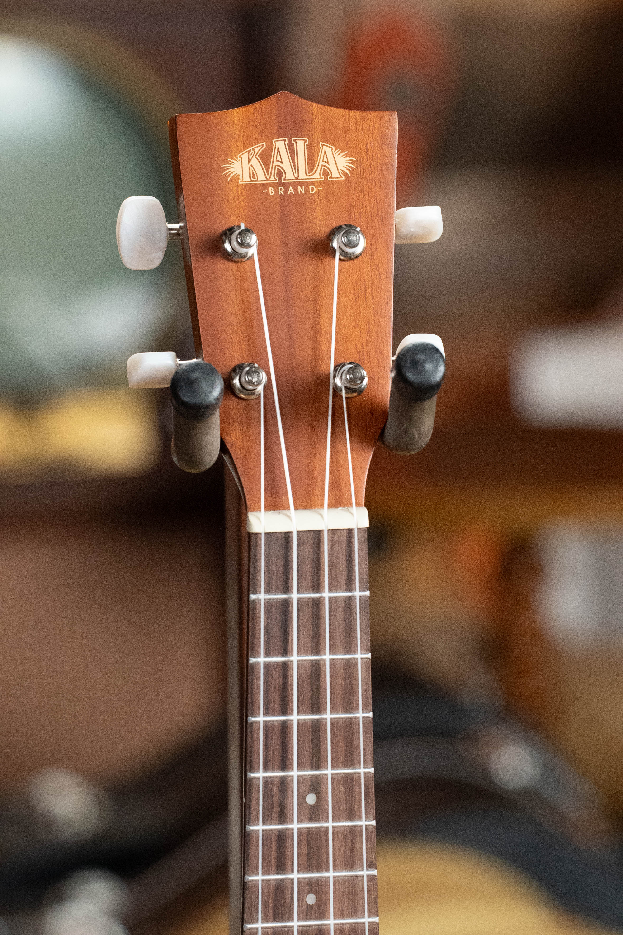Kala KA-15S Satin Mahogany Soprano Ukulele headstock with white tuning pegs and brand logo. - Kala KA-15S Satin Mahogany Soprano Ukulele - Default Title