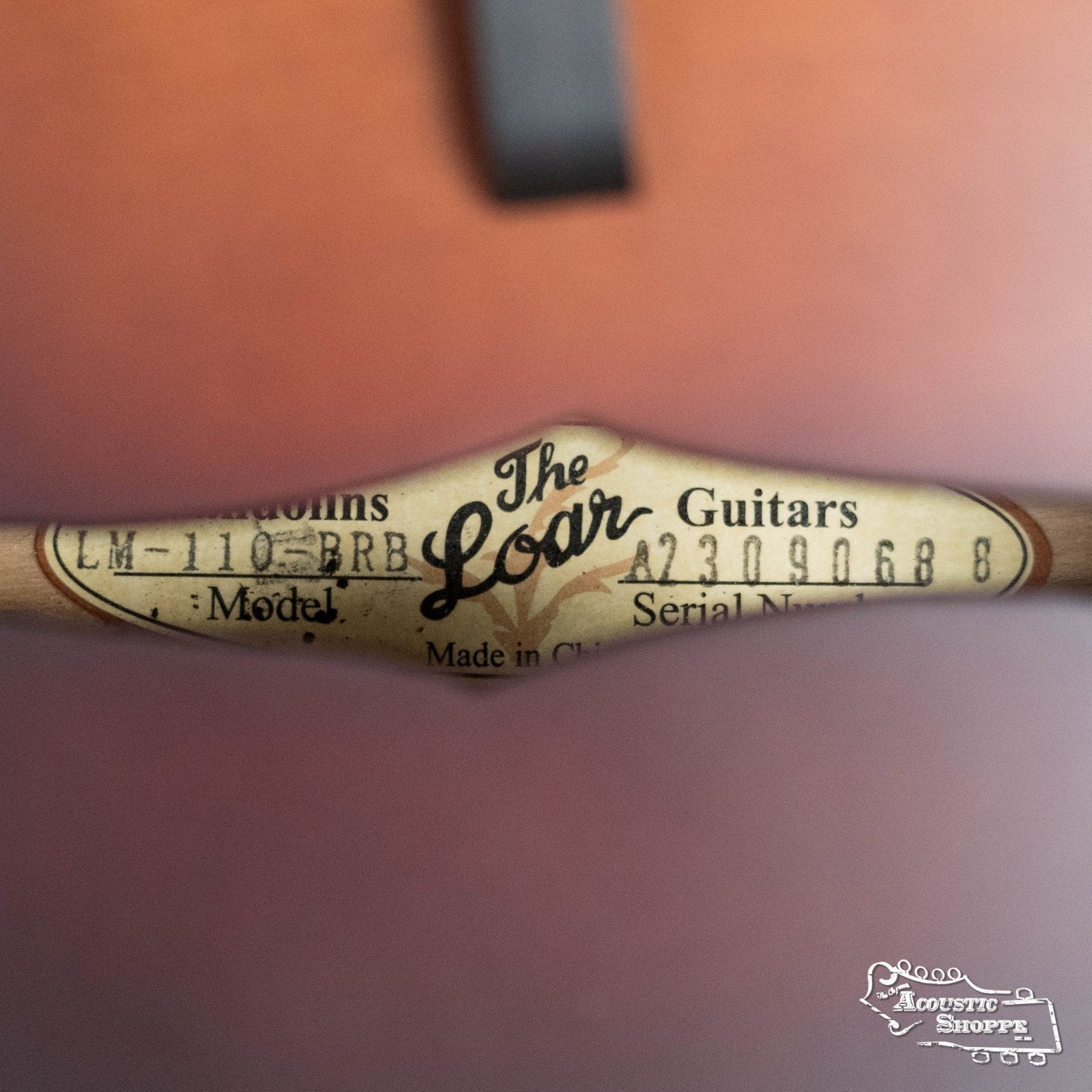Close-up of The Loar LM-110E-BRB "Honey Creek" A-Style Brownburst Mandolin label and serial #0688 inside the instrument, featuring the Acoustic Shoppe logo—classic touches on this solid spruce top mandolin with pickup.