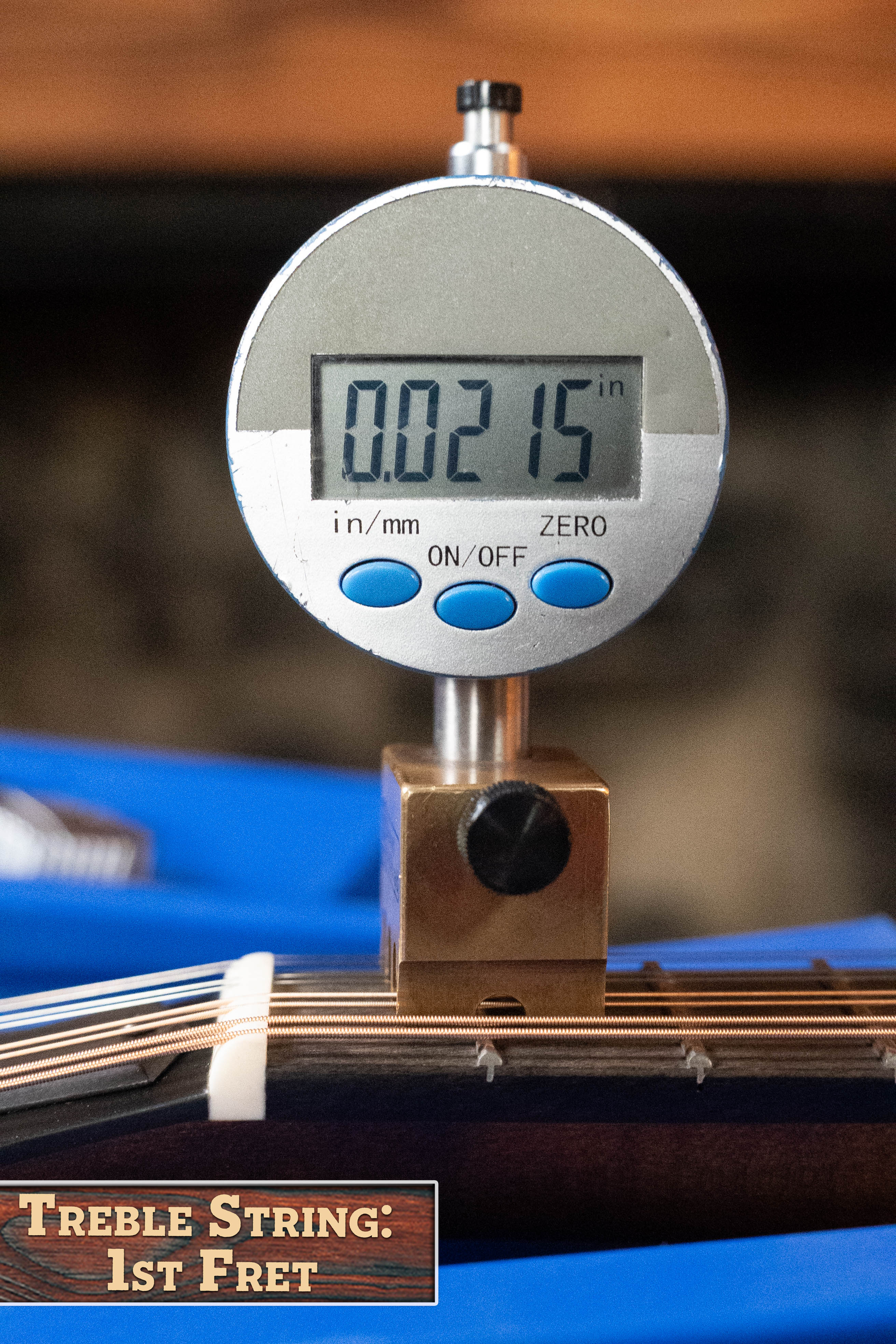 A digital gauge reads 0.0215 inches while measuring the treble string height at the 1st fret of an Eastman Guitars MD305 Spruce/Maple A-Style Hand-Carved Mandolin #3596, as shown in a bottom-left label.