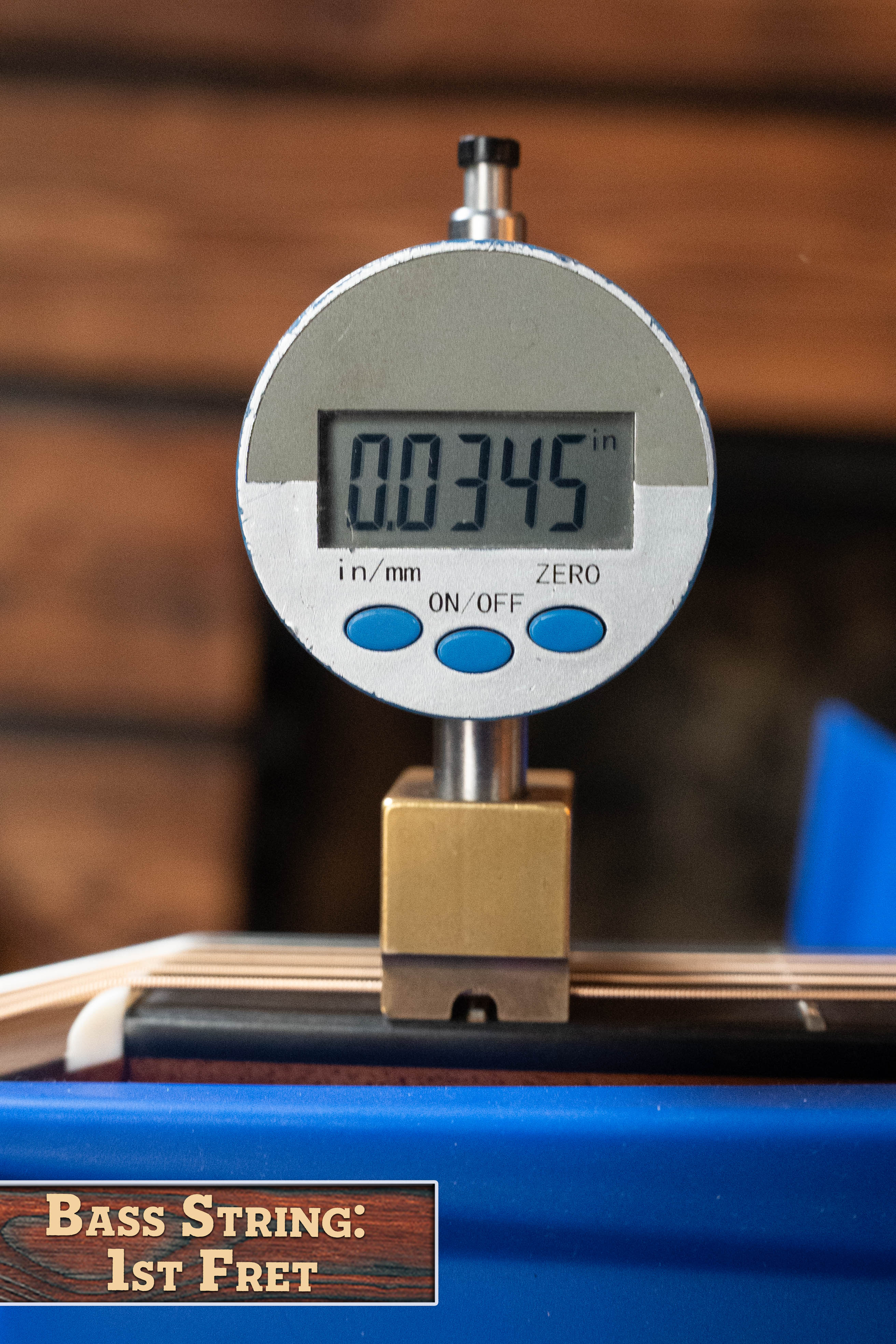 A digital gauge shows 0.0345 inches, measuring the bass string height at the 1st fret of a Martin & Co. Custom Shop HD-28 Style Spruce/Wild Grain Rosewood "D" Dreadnought Acoustic Guitar #7410. A label reads Bass String: 1st Fret.