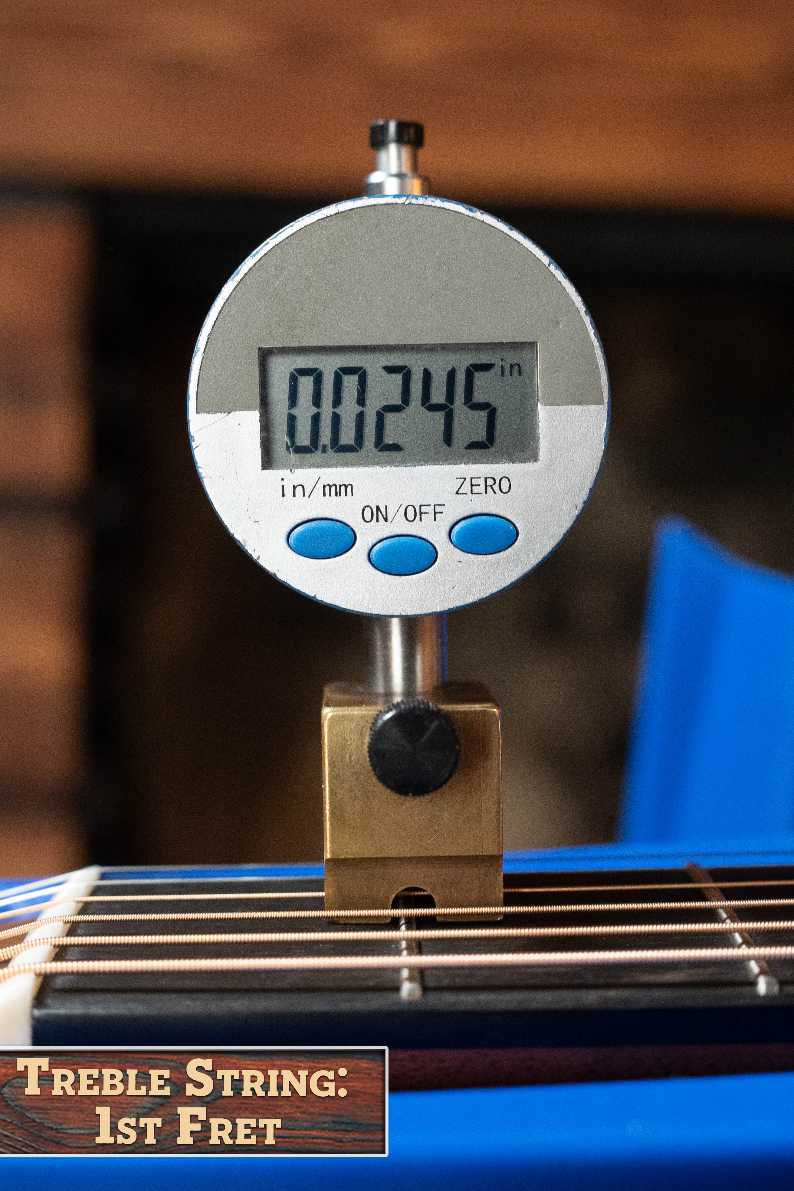 A digital gauge shows the string height at the 1st fret of a Martin & Co. Custom Shop HD-28 Style Spruce/Wild Grain Rosewood "D" Dreadnought (#7410) as 0.0245 inches, with visible frets and strings and text: Treble String: 1st Fret.