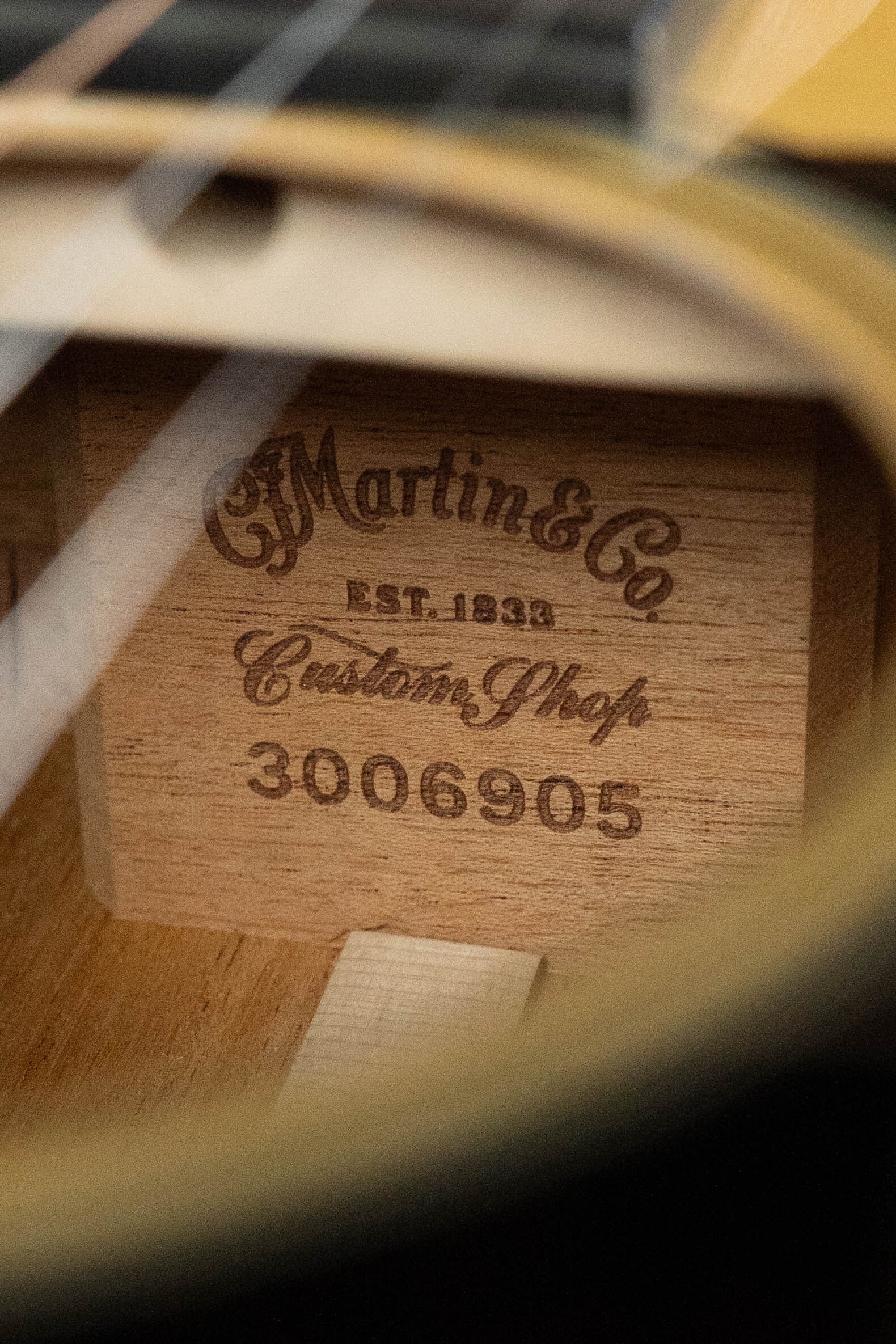 Close-up view of the interior label on a Martin & Co. Custom Shop D-18V Adirondack/Mahogany Dreadnought Acoustic Guitar #6905, engraved with "CF Martin & Co EST. 1833 Custom Shop 3006905".