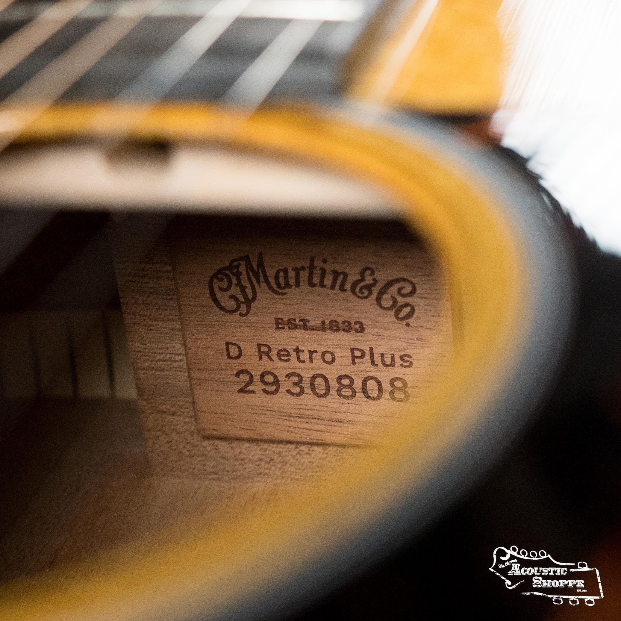Close-up of the interior label of a Martin & Co. DE Retro Plus Torrefied Spruce/Mahogany Dreadnought Guitar w/Martin Electronics #0808, showing strings, soundhole, and The Acoustic Shoppe logo in the bottom right corner.