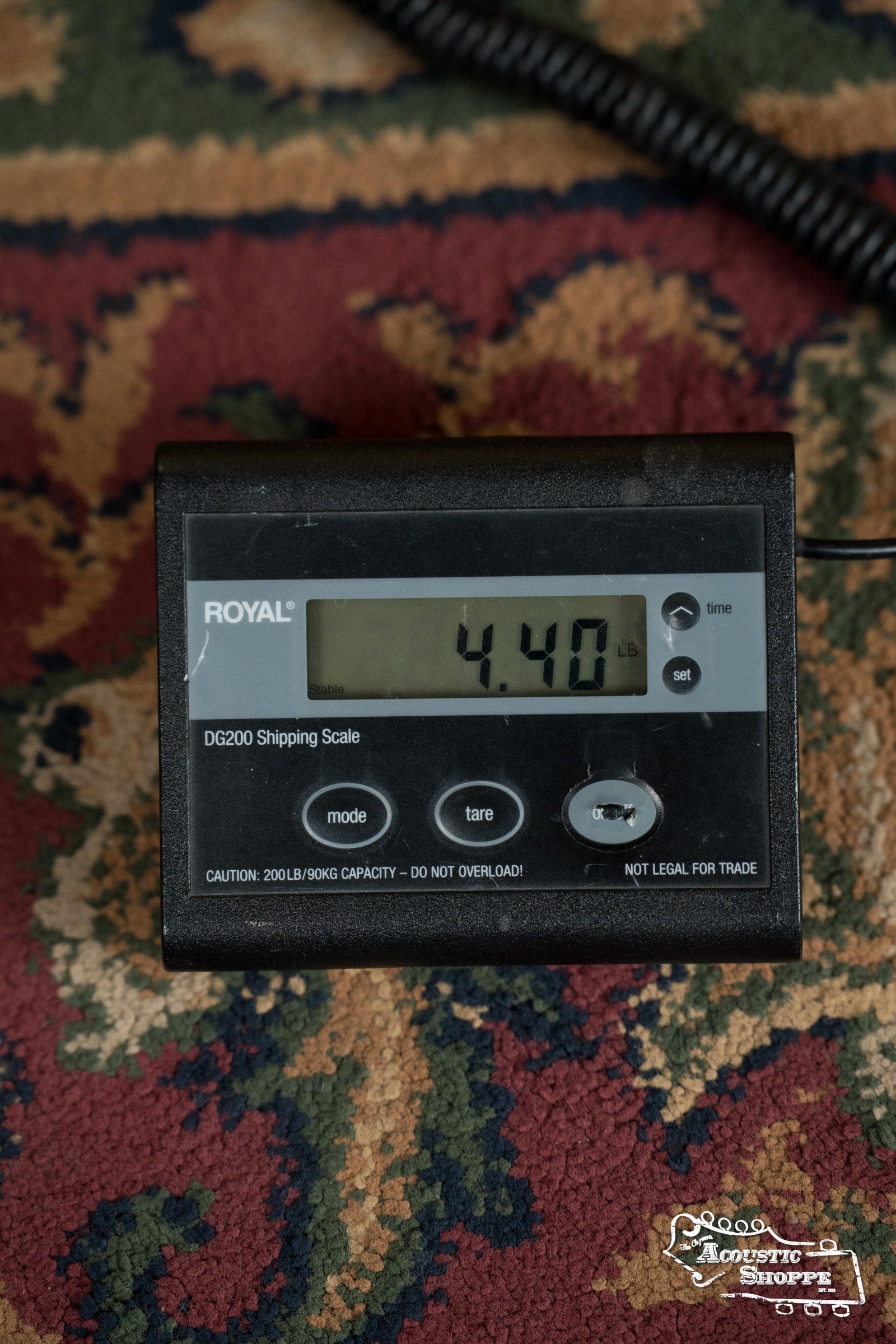 A Royal DG200 digital shipping scale on a patterned carpet shows 4.40 lbs—ideal for safely shipping your Martin & Co. DE Retro Plus Torrefied Spruce/Mahogany Dreadnought Guitar w/Martin Electronics #0808.