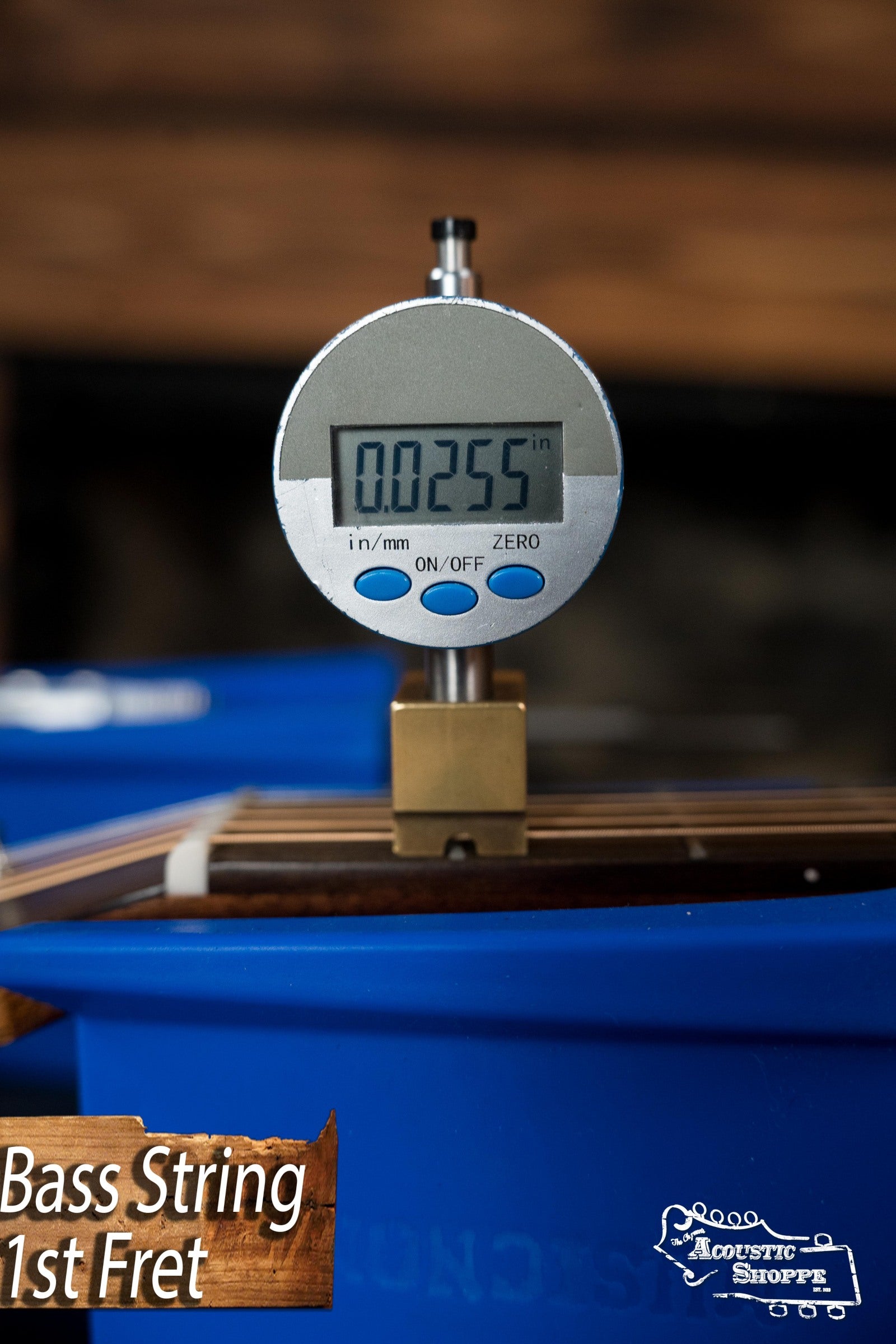 A digital gauge shows a Martin & Co. DE Retro Plus Torrefied Spruce/Mahogany Dreadnought Guitar string at 0.0255 inches above the 1st fret, with Bass String 1st Fret and Acoustic Shoppe logos highlighting its vintage-style tone.