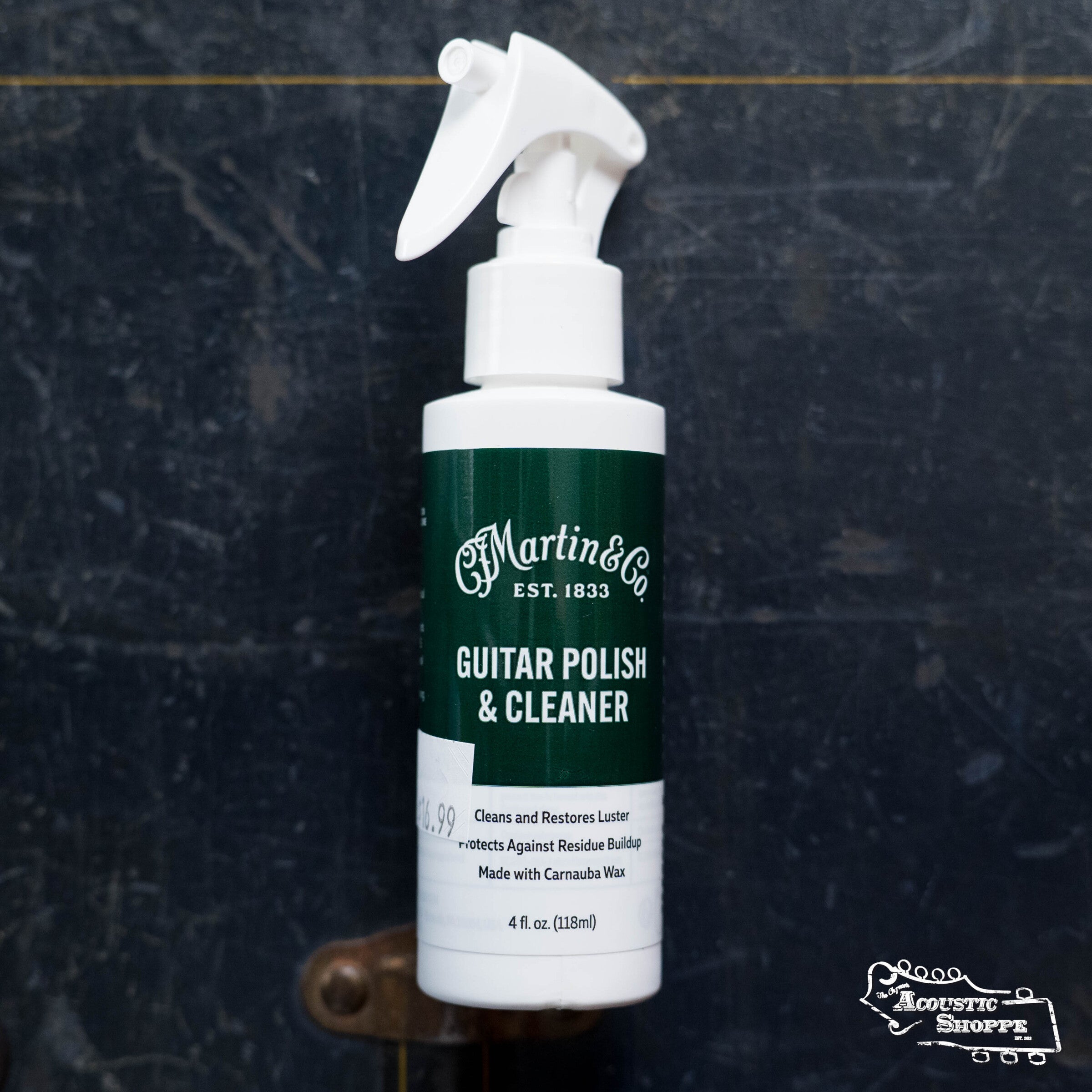 A white spray bottle of Martin & Co. Martin Guitar Cleaner Polish stands upright against a dark background, with a small Acoustic Shoppe logo in the bottom right corner.