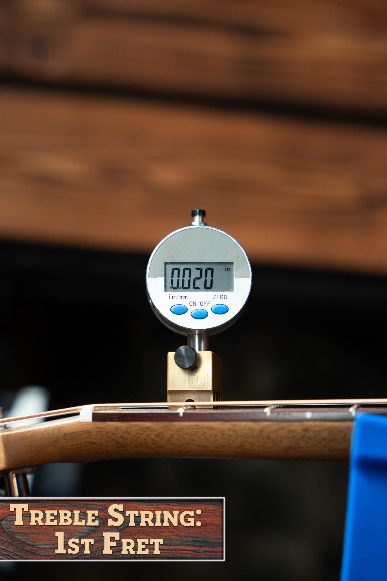 A digital gauge shows 0.020 while measuring the treble string height at the 1st fret of a Maton Guitars T.E. Personal Spruce/Queensland Maple Deep Body OO Guitar w/Electronics #0085. A sign reads, Treble String: 1st Fret.