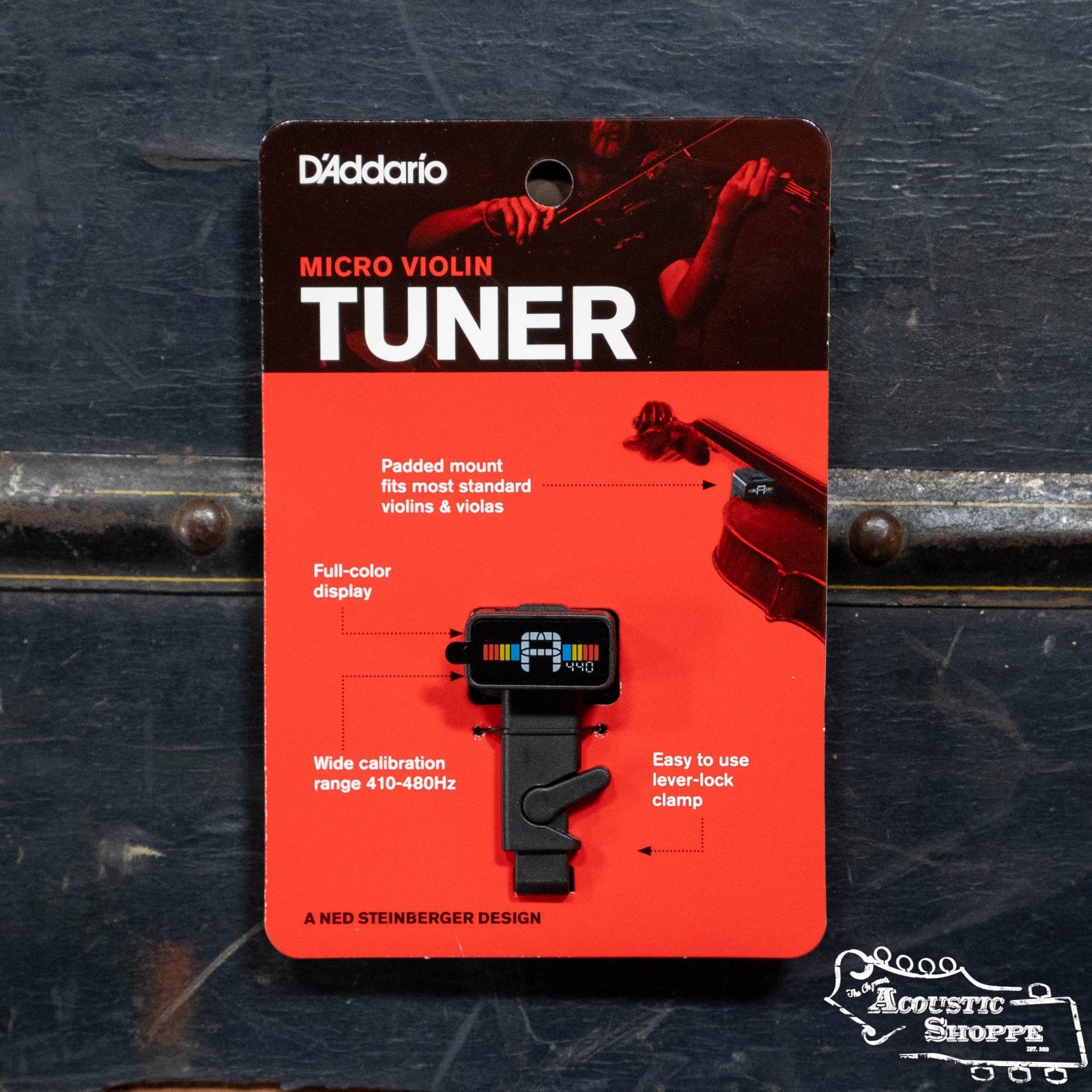The D'Addario PW-CT-14 Micro Violin Tuner by D'Addario, shown in packaging against a dark background, features a padded mount, full-color display, wide tuning range, and an easy lever-lock clamp for precise tuning.